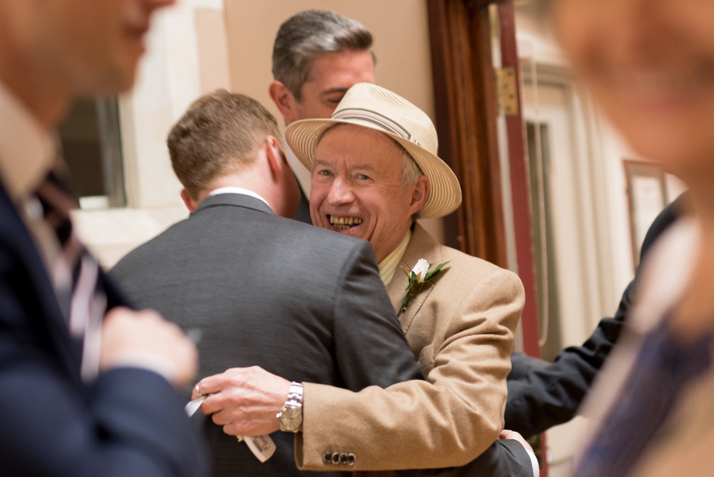 Groom embraces father on wedding day