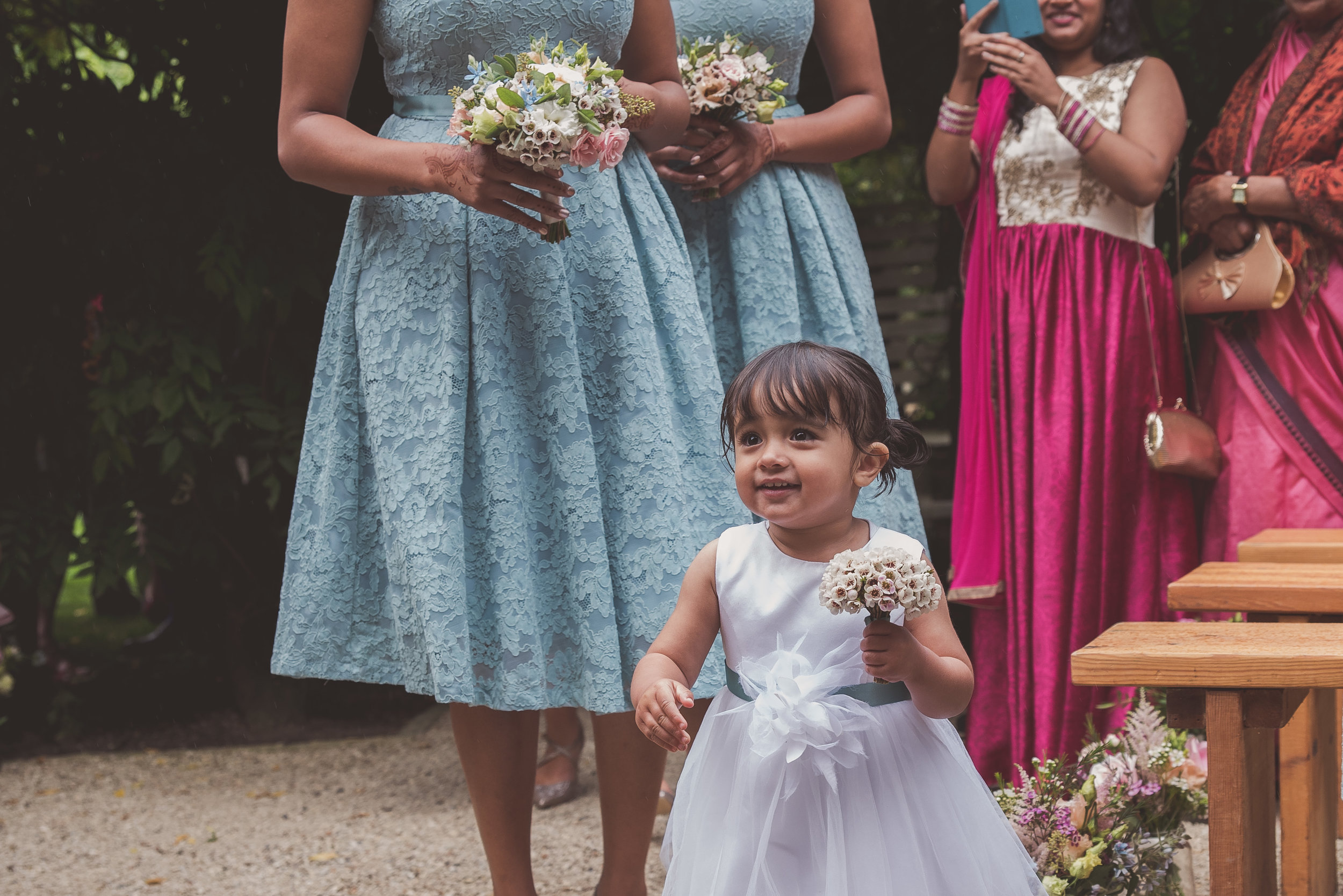 Flower girl at wedding ceremony at The Tythe Barn