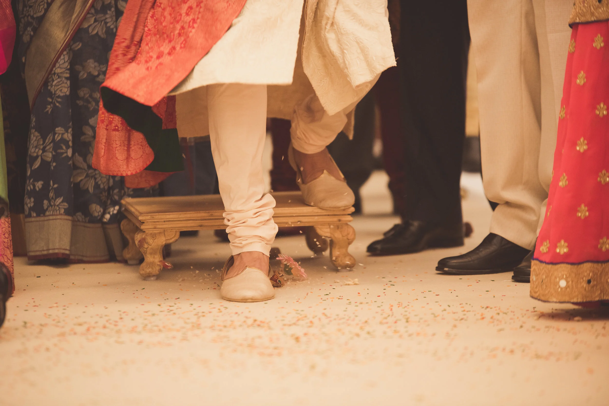 Groom breaks coconut at the Oshwal Centre