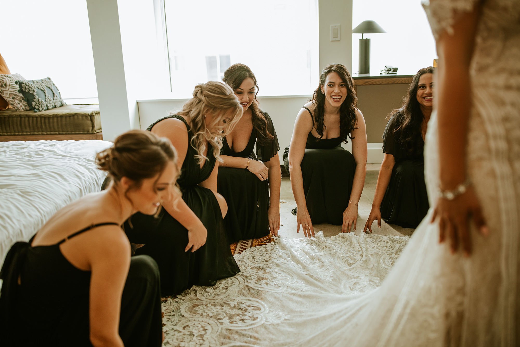 Bridesmaids helping with dress
