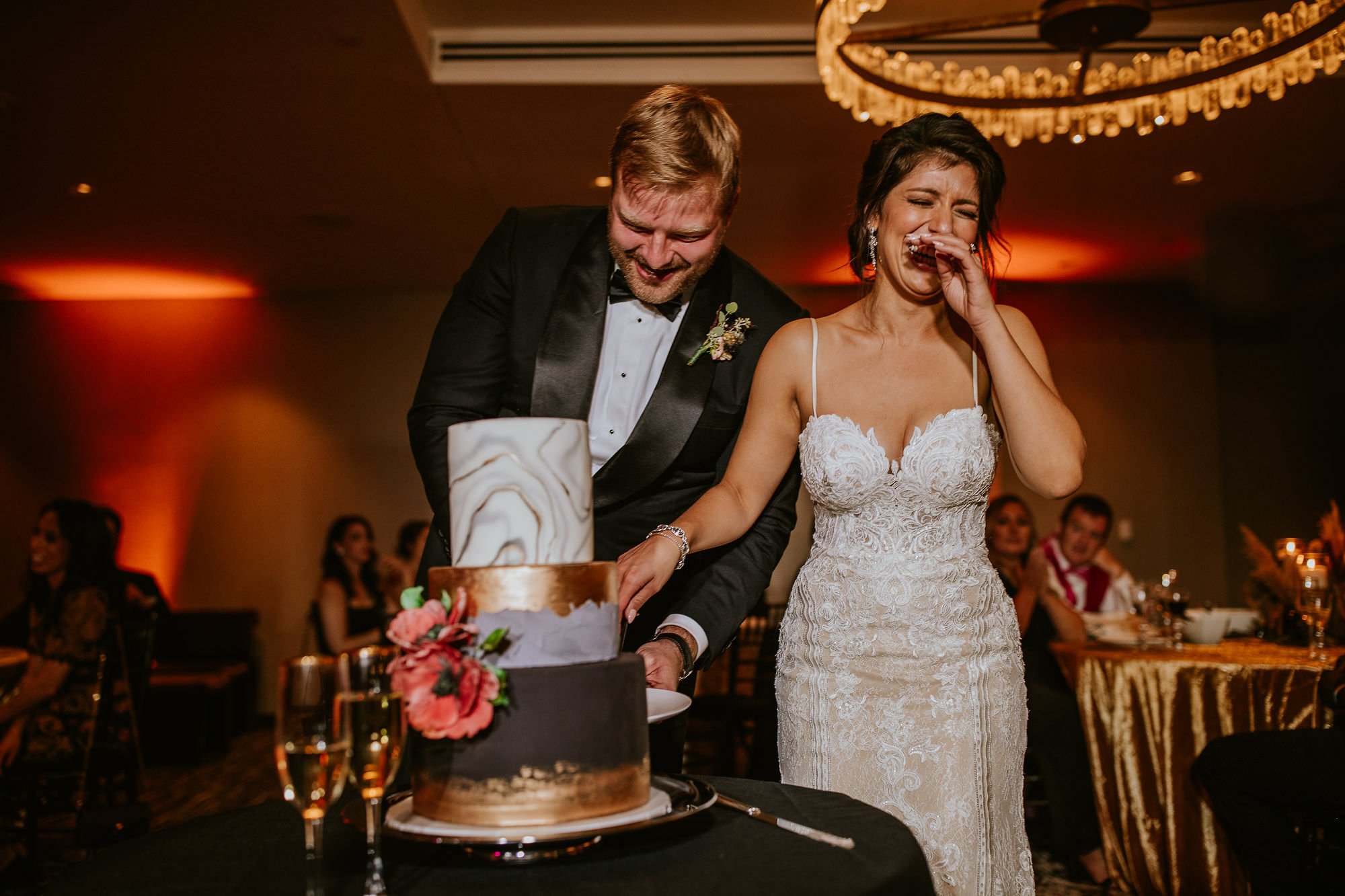 Laughing while cutting the cake