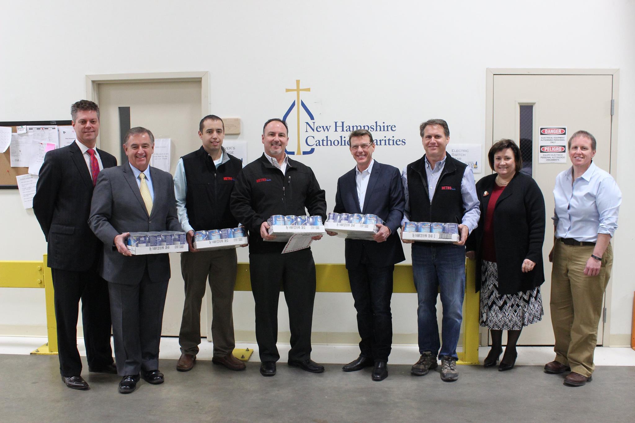 L-R Tom Blonski, NH Catholic Charities, John Dumais, NH Grocers Association and NH Food Bank Advisory Board, Mark Makmann, CFO Metro Walls, Mike Dion, President, Metro Walls, Arthur Sullivan, NH Food Bank Advisory Board, Steve Gagnon, VP of Operations, Metro Walls, with Dominque Rust, and Mel Gosselin, NH Food Bank Executive Director.