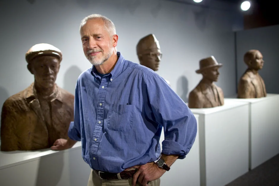 James Barnhill, with his art (Greensboro Four) on display at the African American Atelier in Greensboro Cultural Center on Monday, November 21, 2011, in Greensboro, NC.James Barnhill, an associate professor in the department of visual and performing arts at North Carolina A&T State University, as an exhibition, entitled The Art of James Barnhill, on display at the African American Atelier, Inc. This exhibition features 25 pieces by Barnhill of drawings, paintings and sculptures. (names and location CQ by jw) (Jerry Wolford, news-record.com)