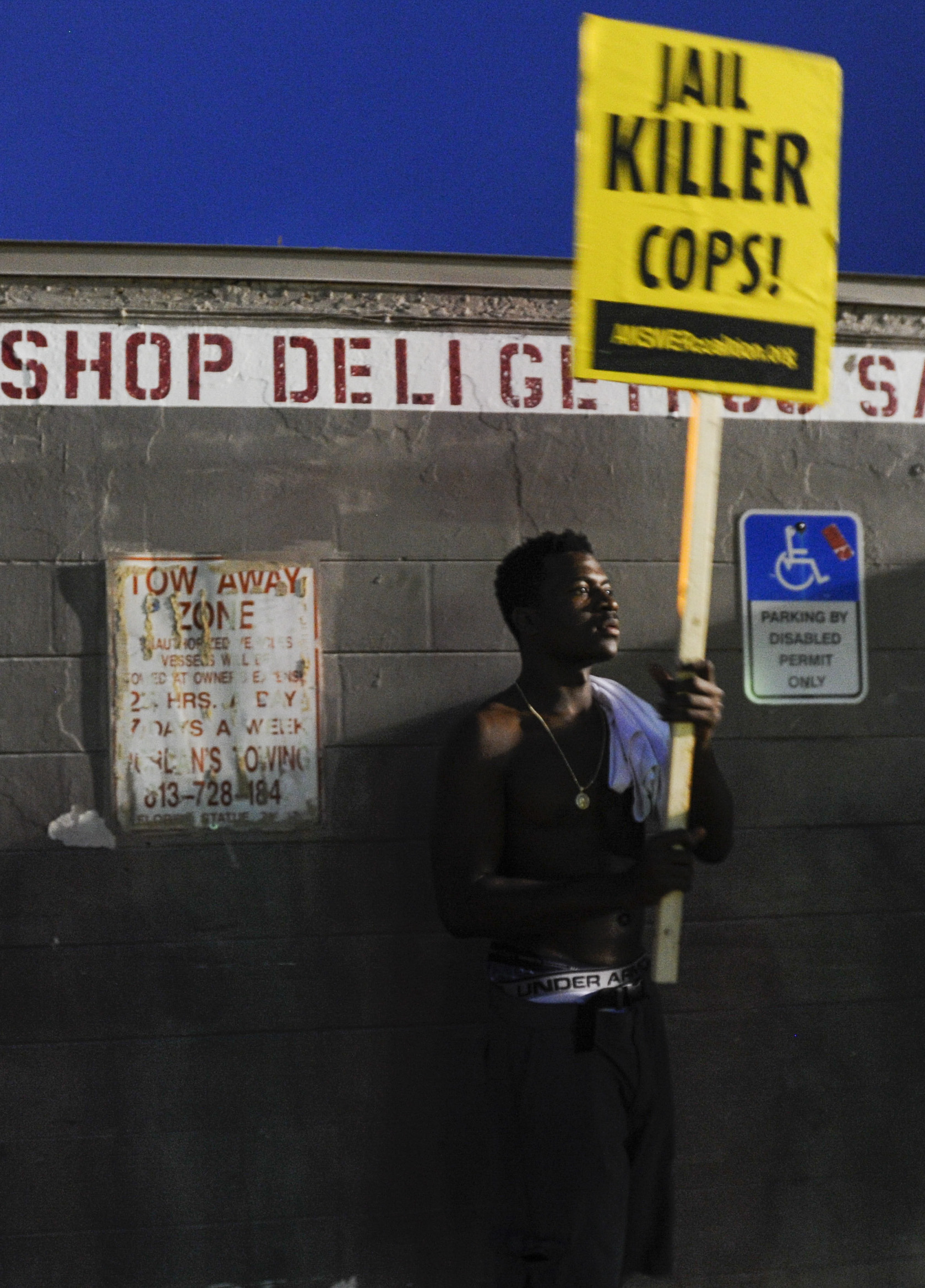  Trey Rumlin, an 18-year-old Tampa resident, stands nearby the Get N Go convenience store where friend Levonia Riggins worked during a gathering on South 78th Street in Tampa, FL. "Daddyman was like a bro to me," Rumlin said, referencing Riggins' nic