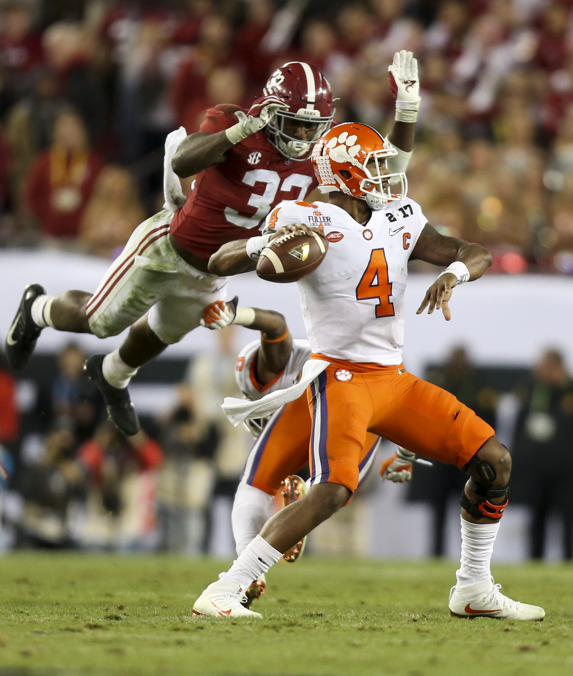  Clemson Tigers quarterback Deshaun Watson (4) prepares to throw the ball as Alabama Crimson Tide linebacker Rashaan Evans (32) leaps to tackle Watson during the second half of the College Football Playoff National Championship game in Tampa, FL. The