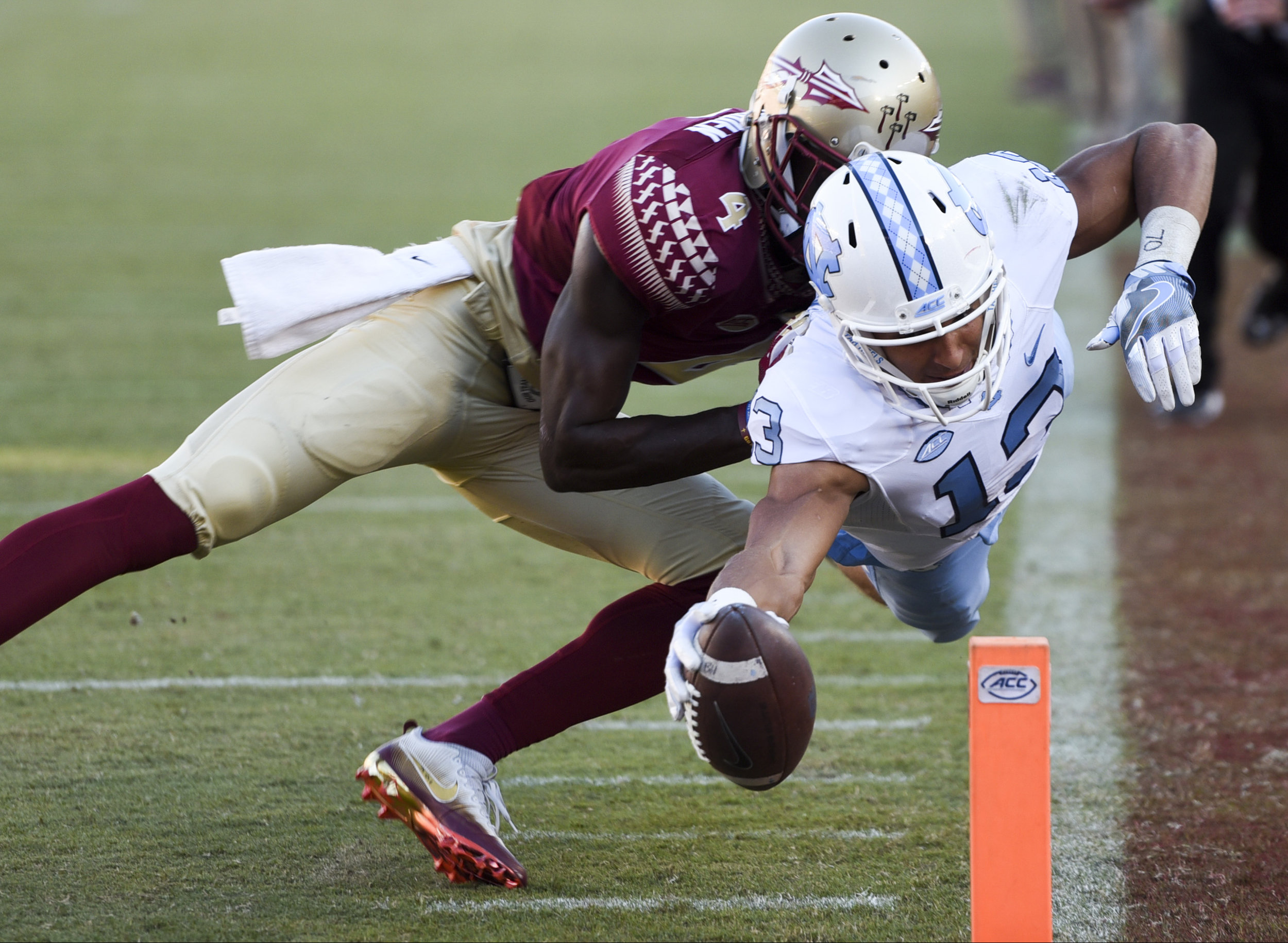  North Carolina Tar Heels wide receiver Mack Hollins (13) dives into the end zone for a touchdown past Florida State Seminoles defensive back Tarvarus McFadden (4) in the third quarter of the game between the Florida State Seminoles and the North Car