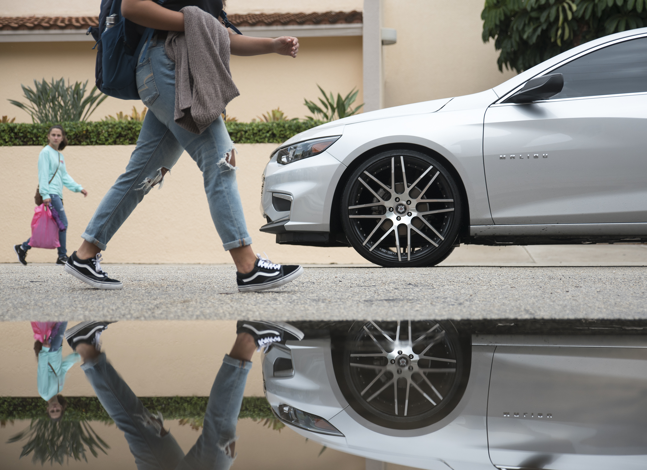  Two unidentified Palm Beach Atlantic students walk along Vallowe Court at Palm Beach Atlantic University after a rainy morning in West Palm Beach, FL. 