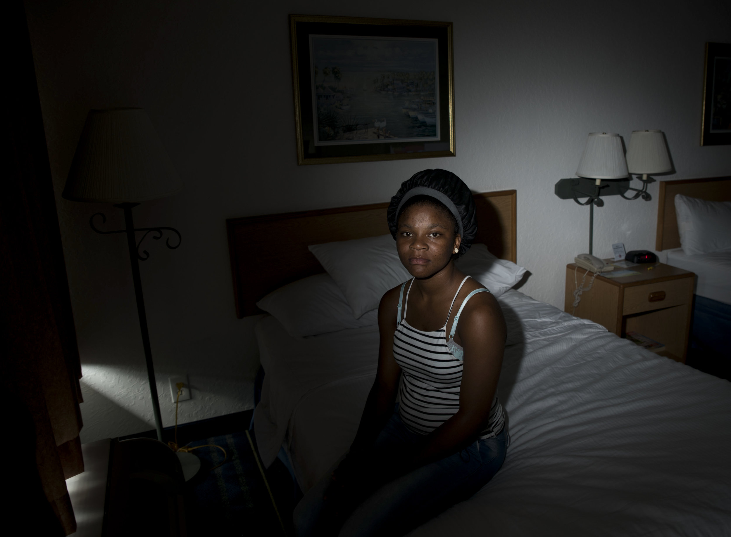  Tranice Smith, 19, of Riviera Beach, sits for a portrait in the motel she's been living in ever since her ex-boyfriend trapped her three children in her apartment and burned the home down. The three infants survived, but Smith knows what she would d