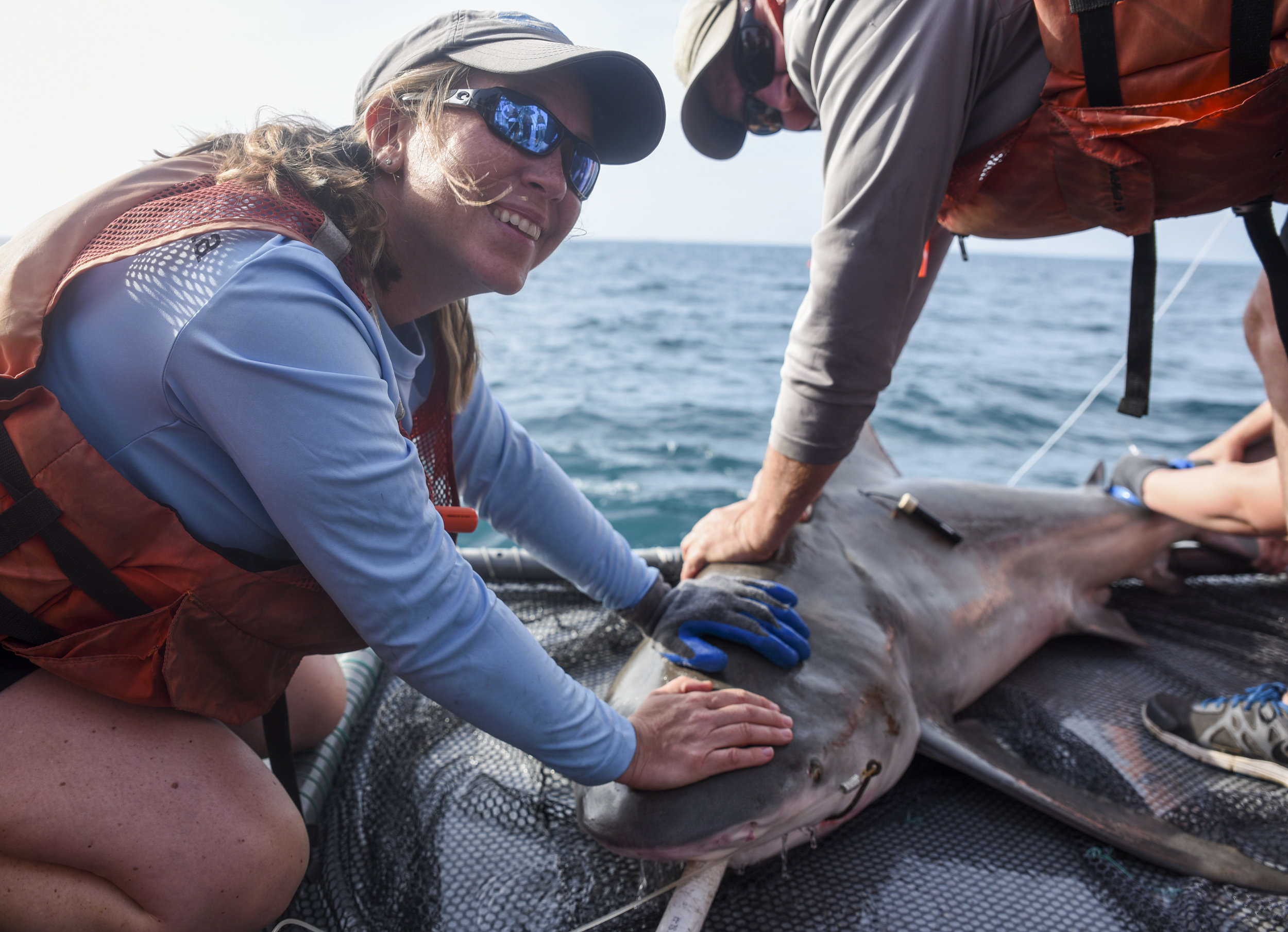  Jayne Gardiner of the New College of Florida smiles after the research crew managed to bring a bullshark measuring 200 centimeters aboard.&nbsp;The shark was outfitted with an acoustic tracker, which enables researchers to track the animal's movemen