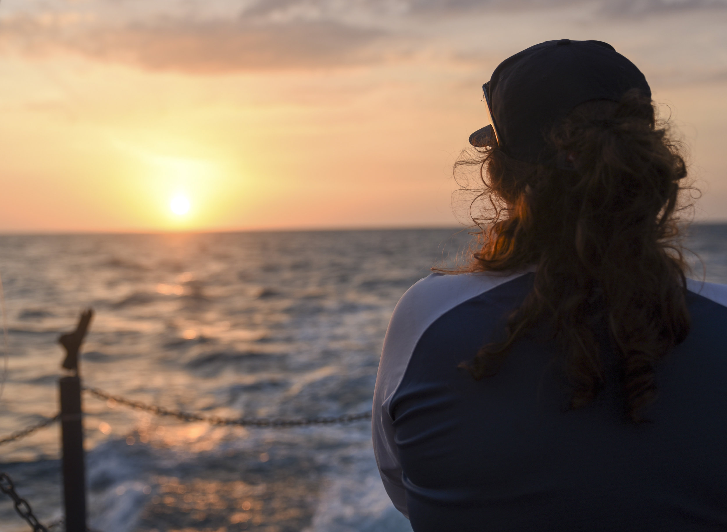  Marlo Leikam, a 21-year-old junior at the New College of Florida, watches the sun set after work is done for the day. 