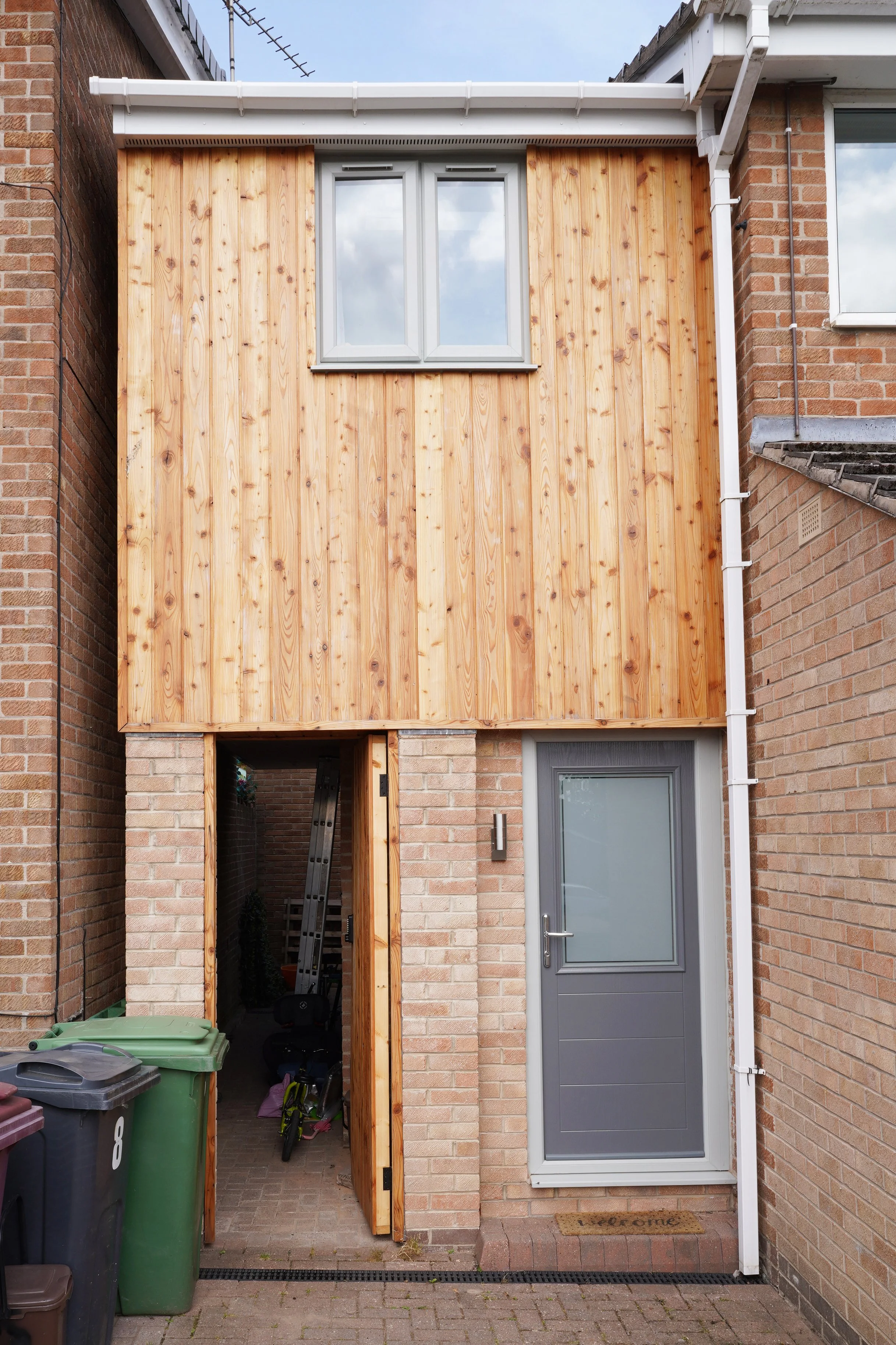 Two storey side extension with timber cladding in Dronfield Woodhouse, Sheffield; extension with sideway path
