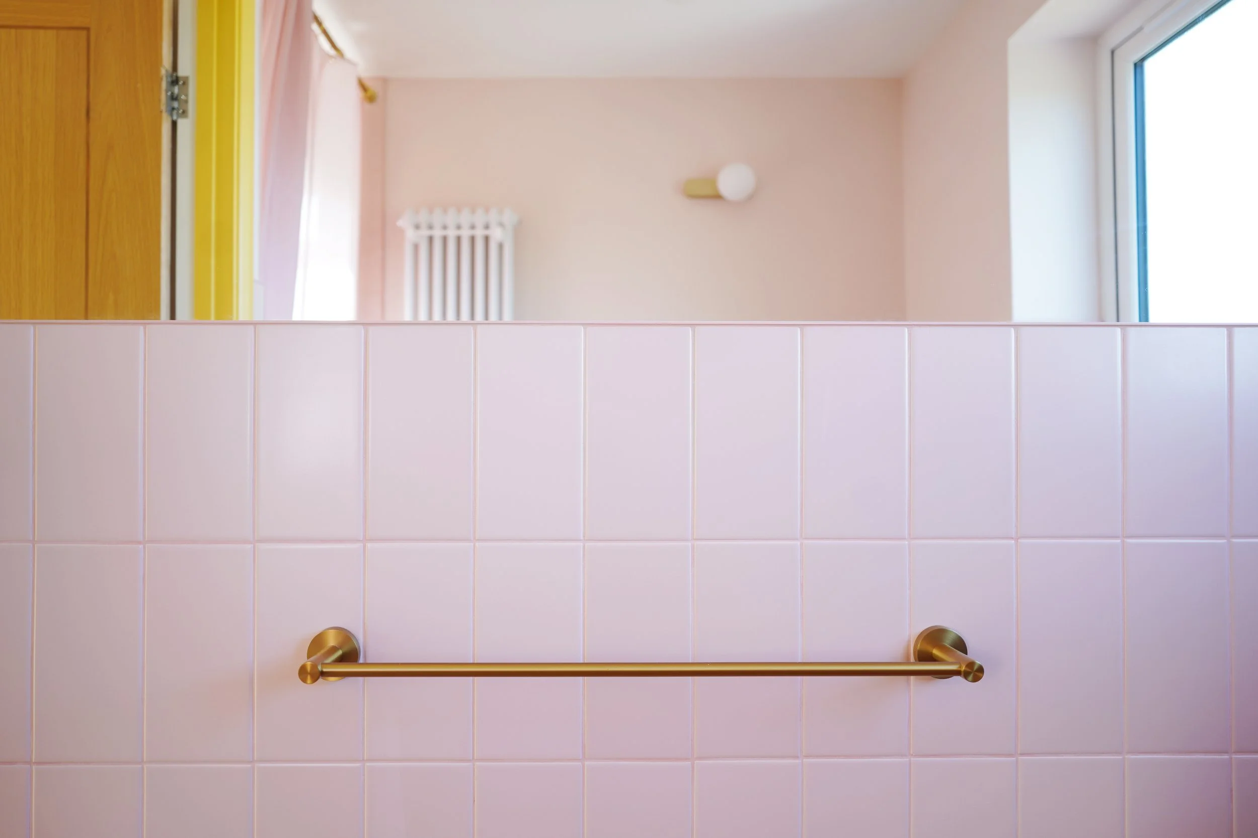 bathroom renovation Sheffield, pink bathroom, blue washbasin, brushed brass towel rail