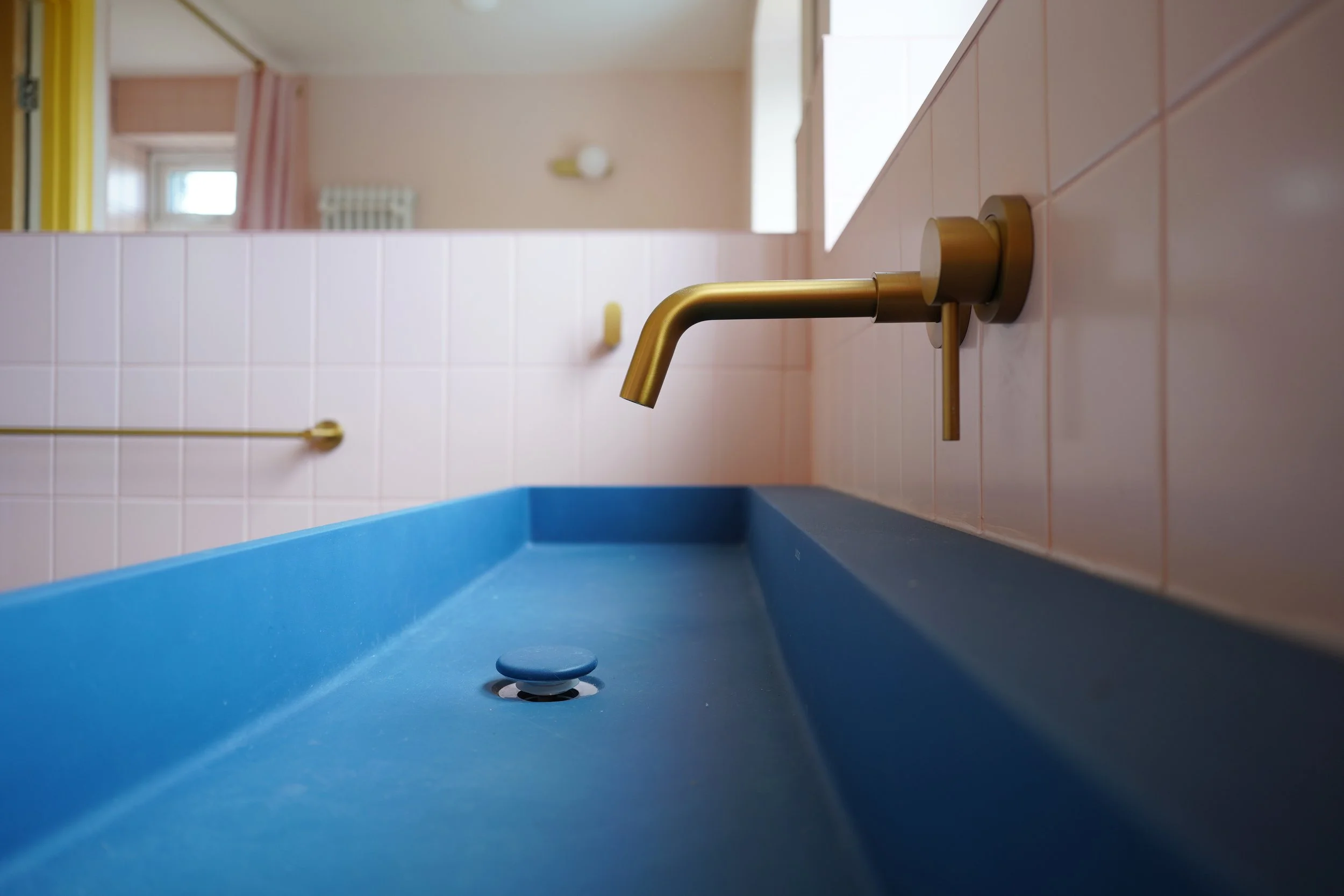 bathroom renovation Sheffield, pink bathroom, blue washbasin, brushed brass tap