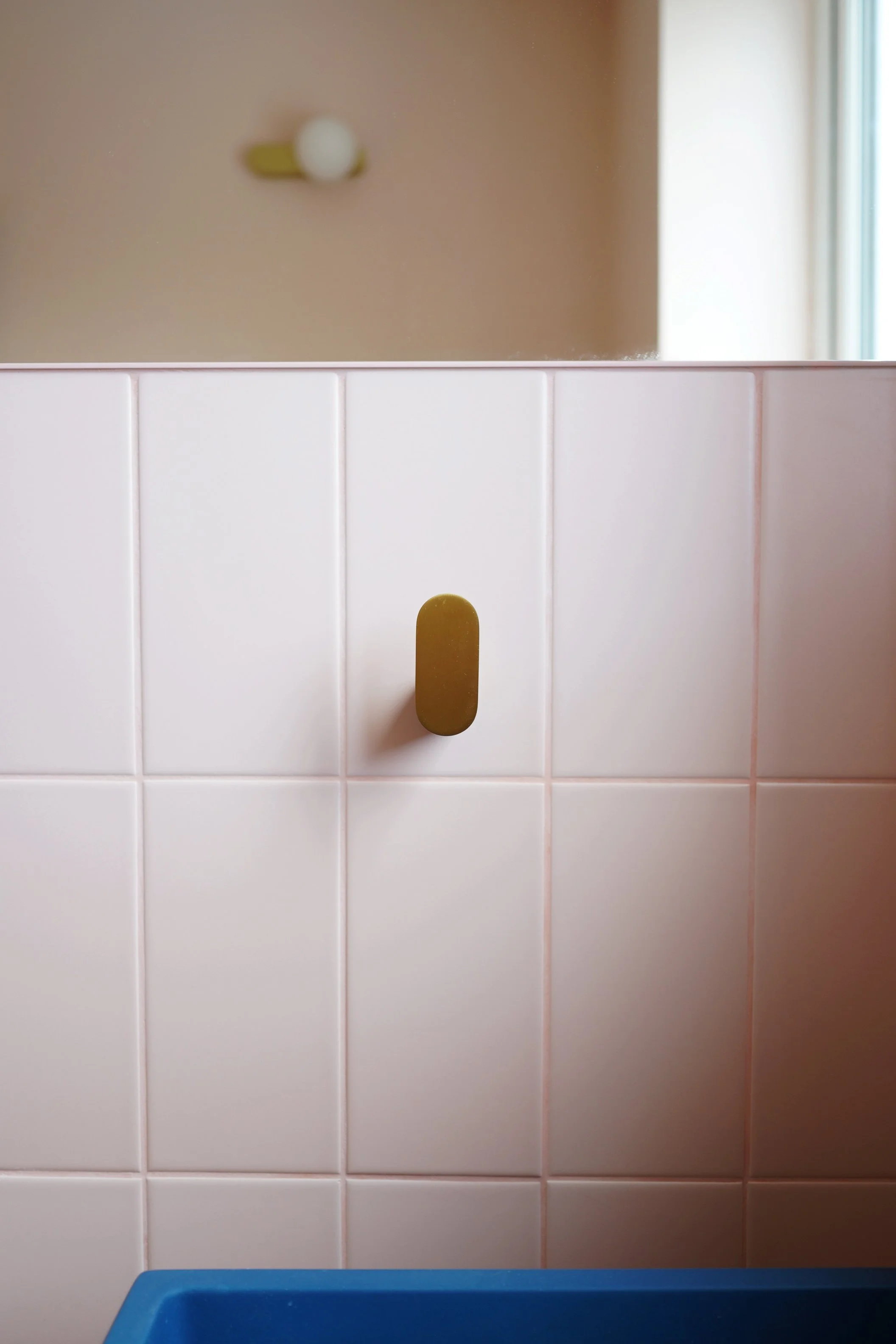 bathroom renovation Sheffield, pink bathroom, blue washbasin, brushed brass book