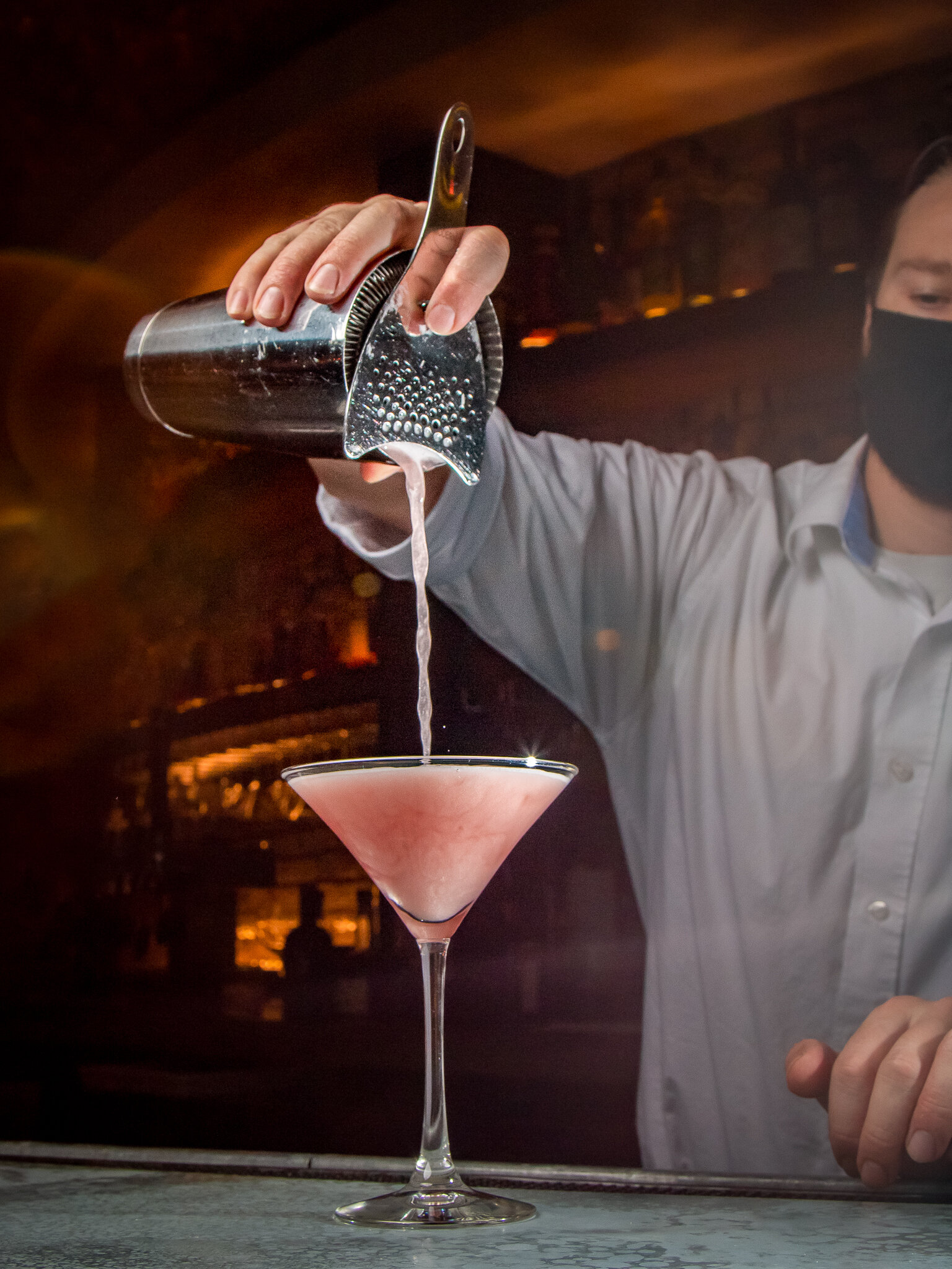 Masked Bartender pouring cocktail-1.jpg