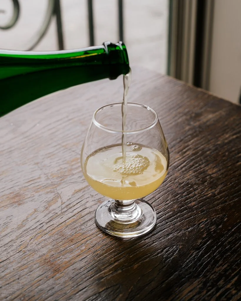 pouring cider into a glass (Copy)