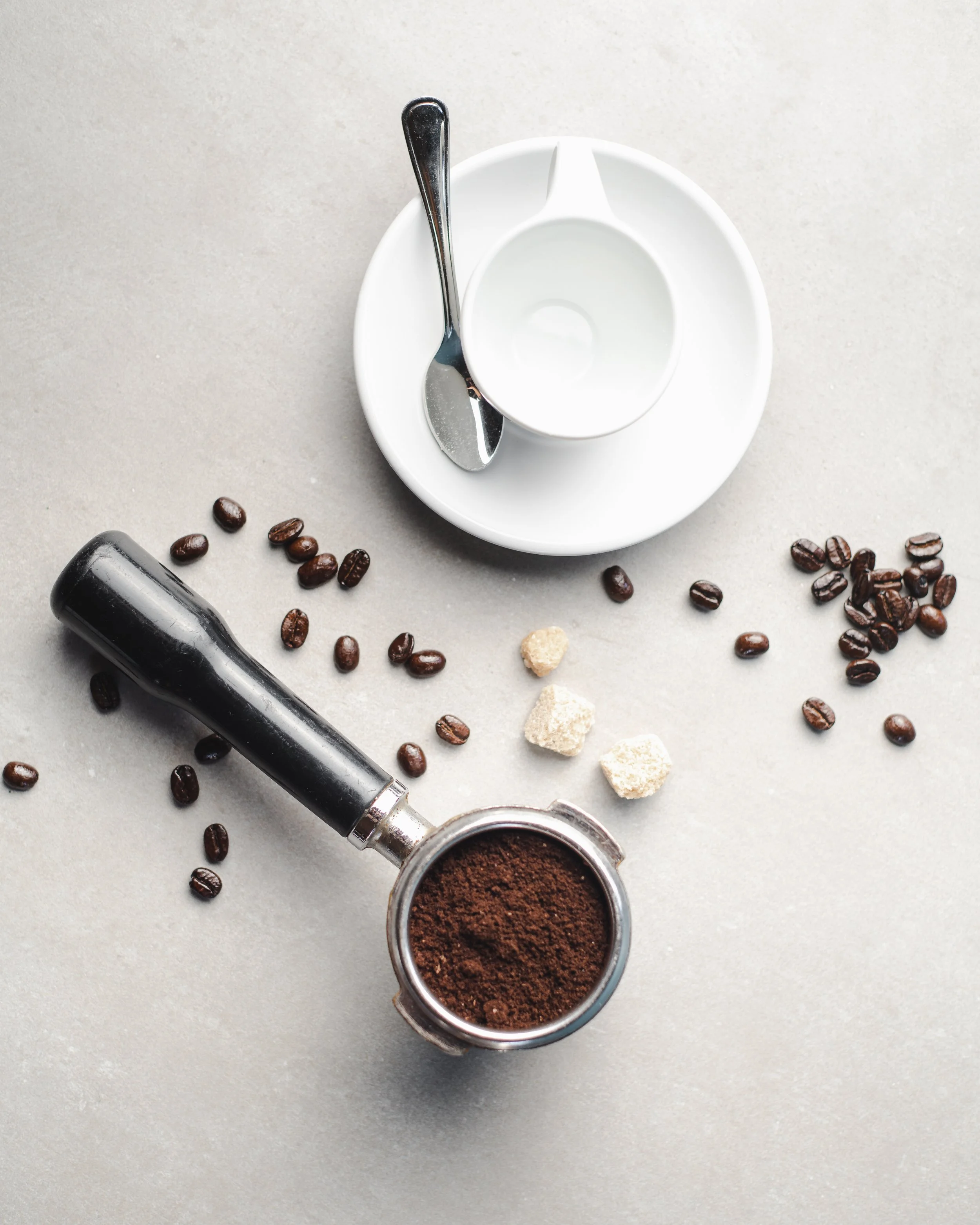 top down espresso in portafilter amidst coffee beans  (Copy)