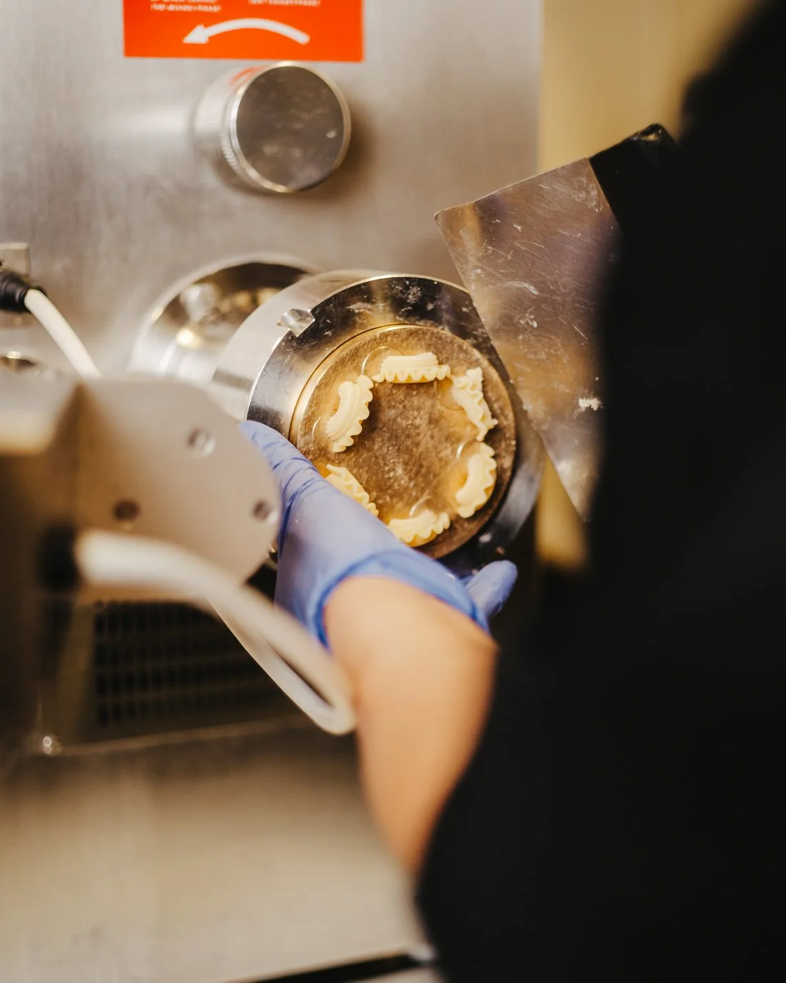 hand cutting creste di gallo pasta shapes in pasta machine  (Copy)