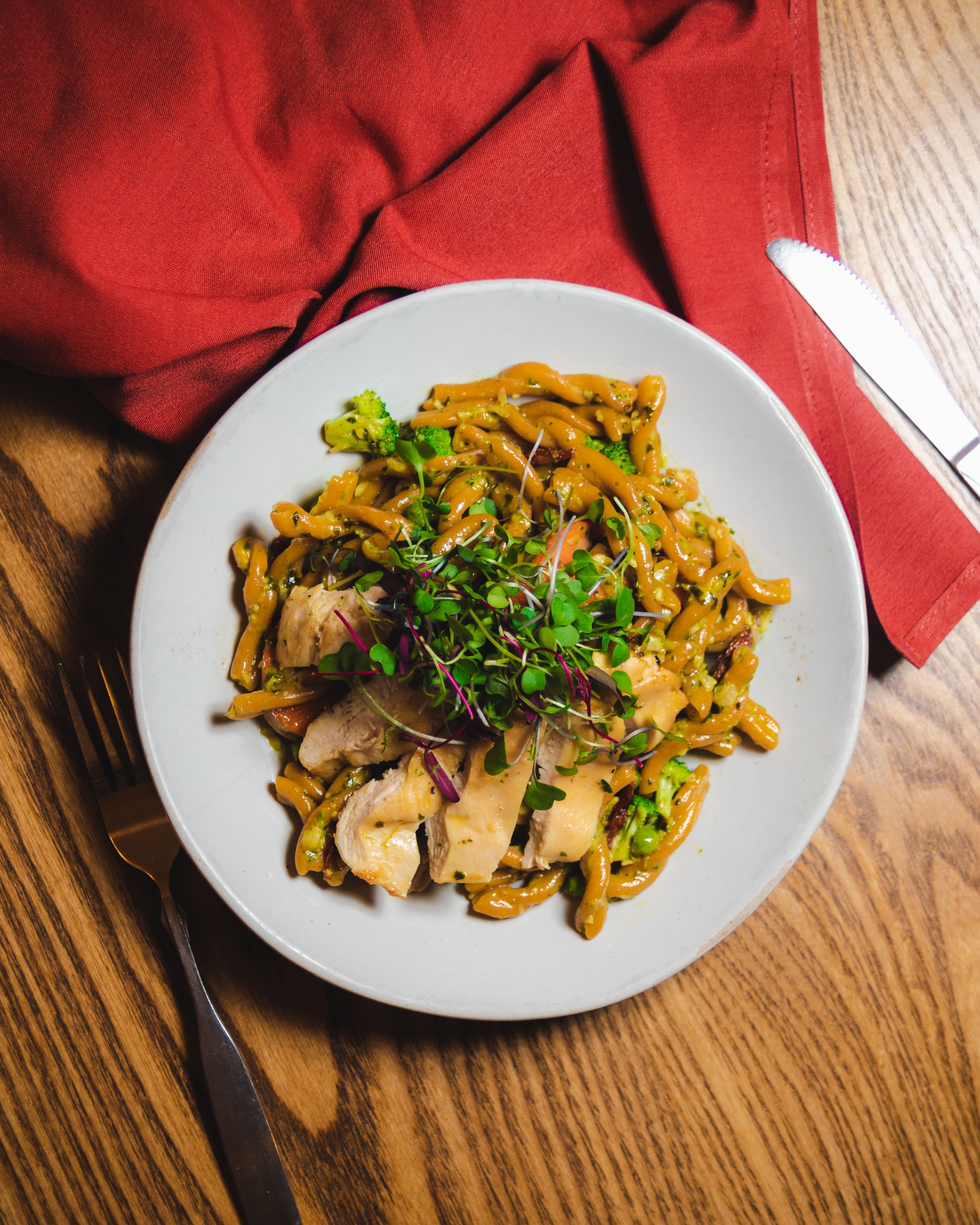 top down chicken and gluten-free pasta with red napkin and knife  (Copy)