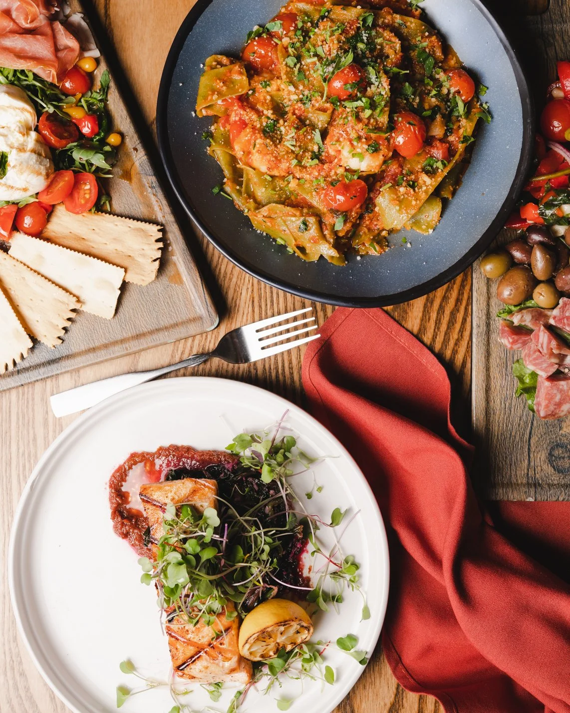 top down of an array of dishes with salmon, shrimp, and charcuterie  (Copy)