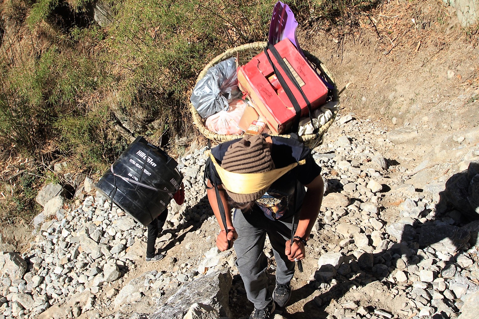 Porters carrying goods and a tank up to Langtang