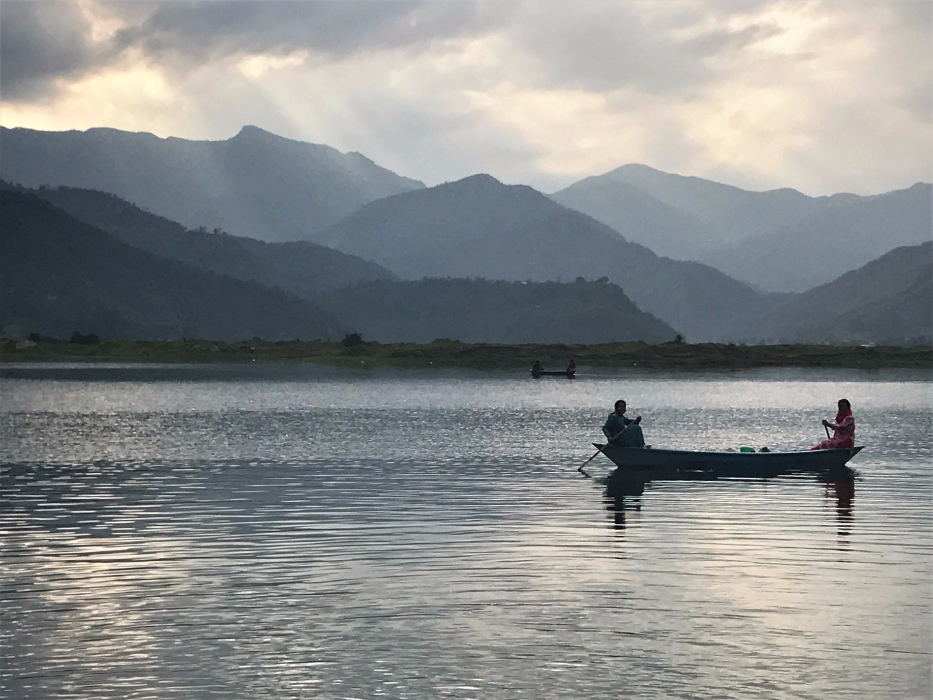 Two women fishing at sunset on Fewa Lake