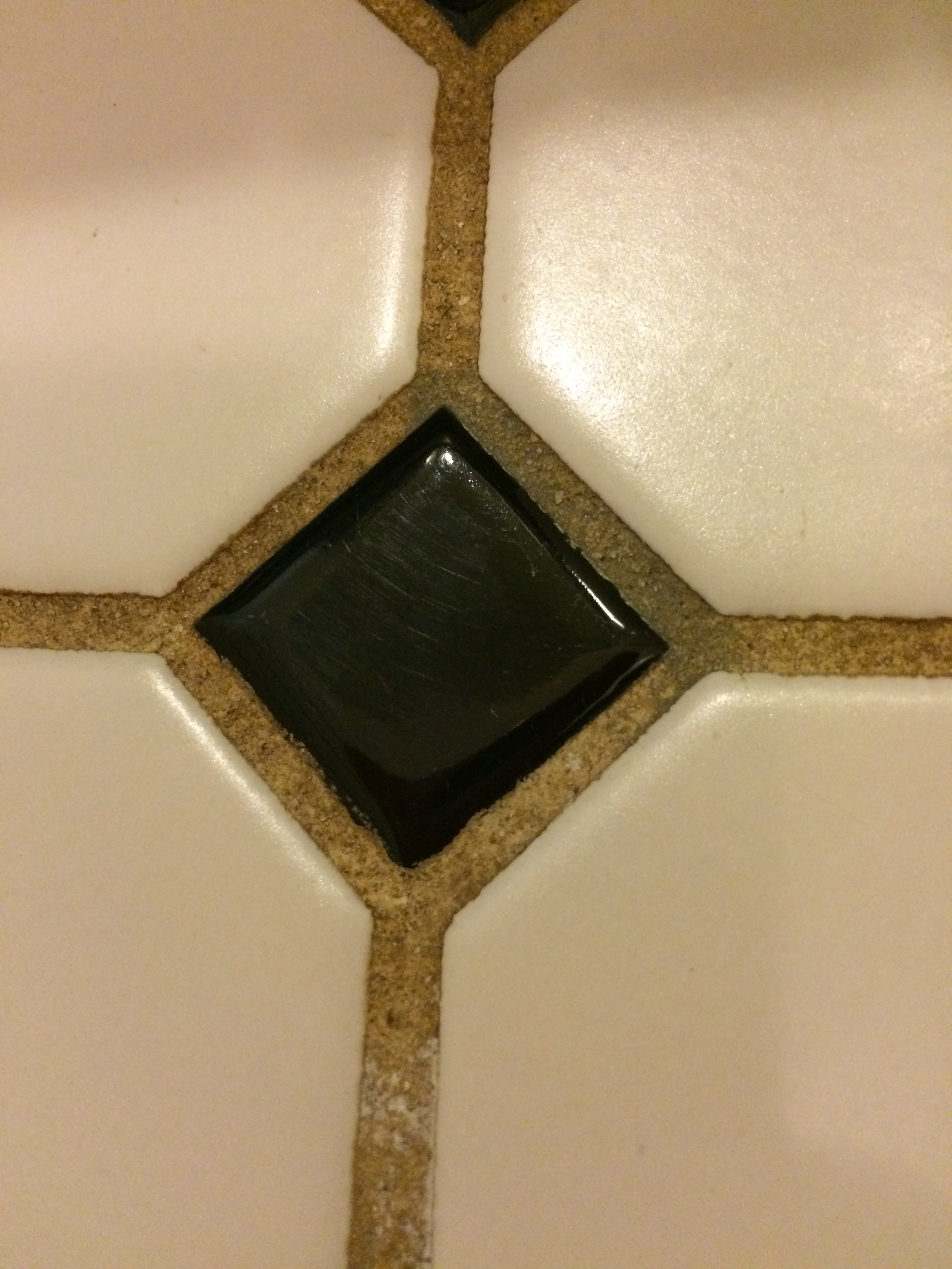 One of the darkest stained portions of the grout. On the top right of the diamond you can see the Grout Renew before I finished the area.