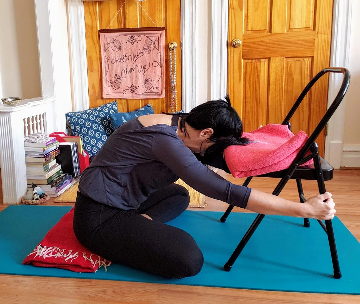 Grab the legs of the chair and extend your arms. Reach forward.
