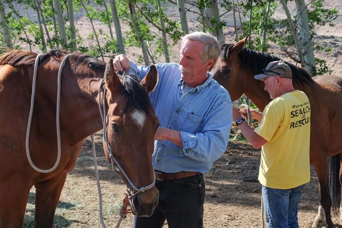 First Responders learn how to catch and halter horses in a field.