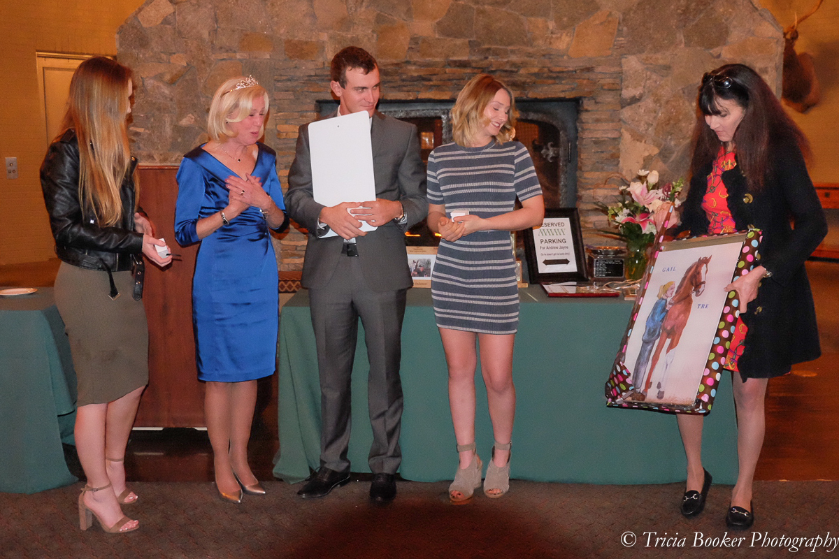 Gail receives the canvas print of her new mural painted in the indoor arena.