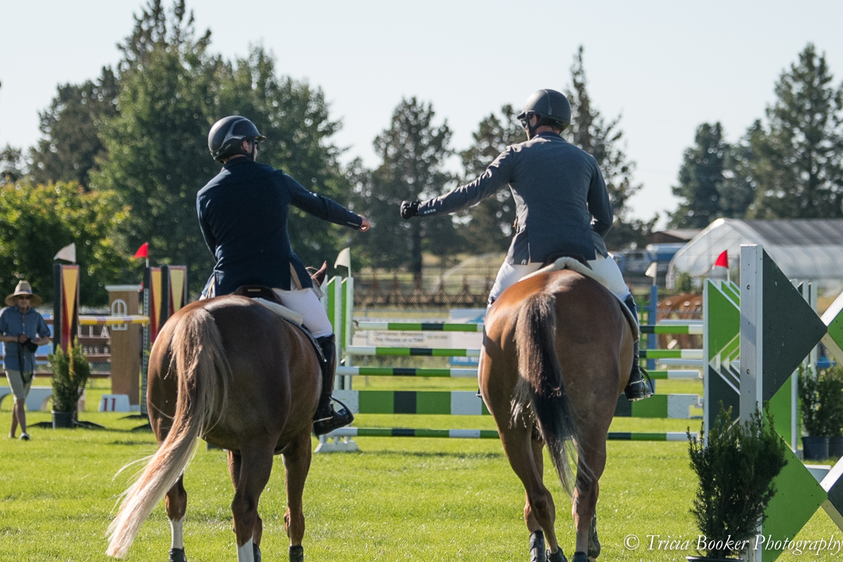 Kevin Winkel and Osophia, left, and Andrew Jayne with Outlier fist pump during the $25,000 Oregon High Desert Classic Grand Prix