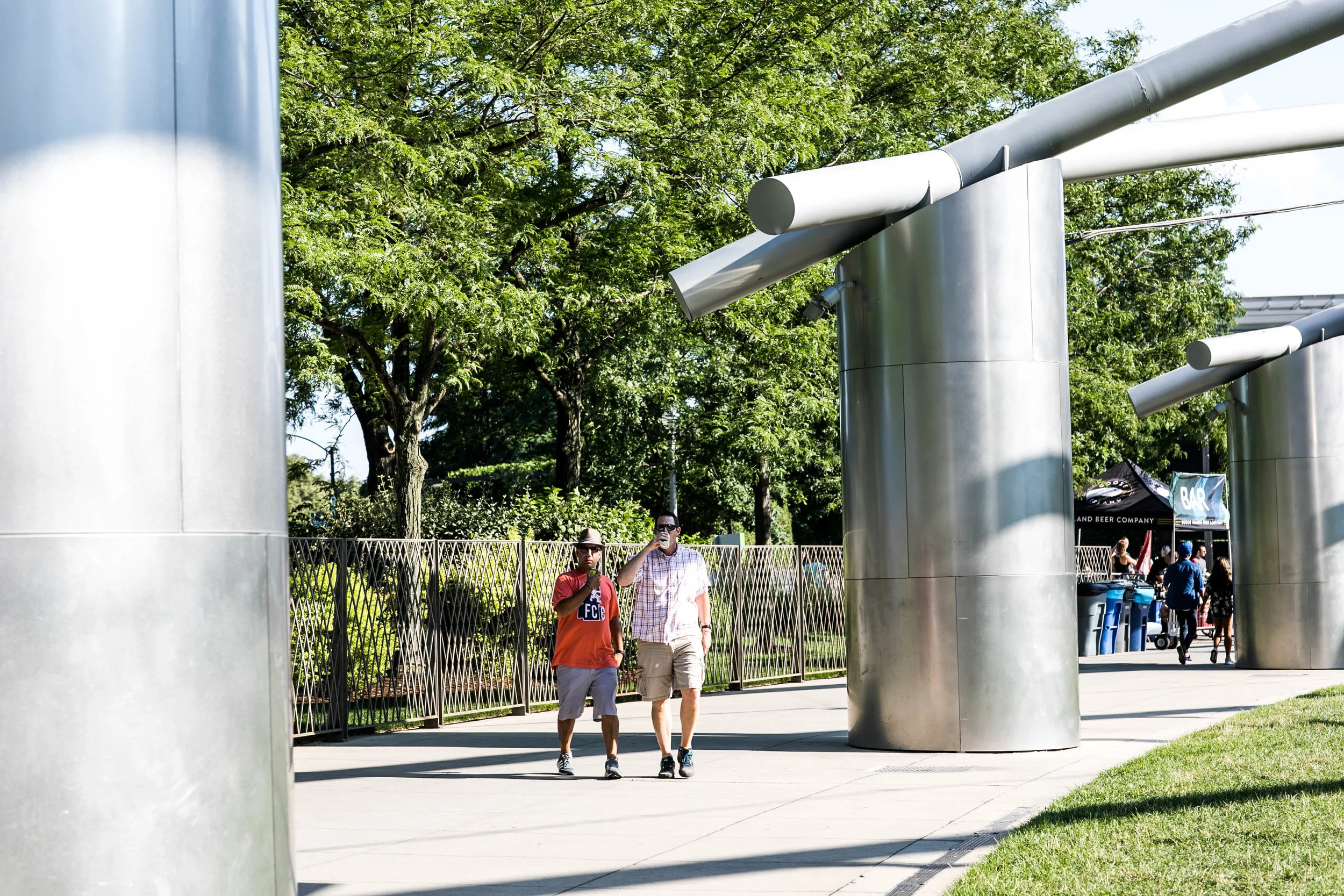 the dads grabbing a local brew goose island walking thru jay pritzker pavilion. 