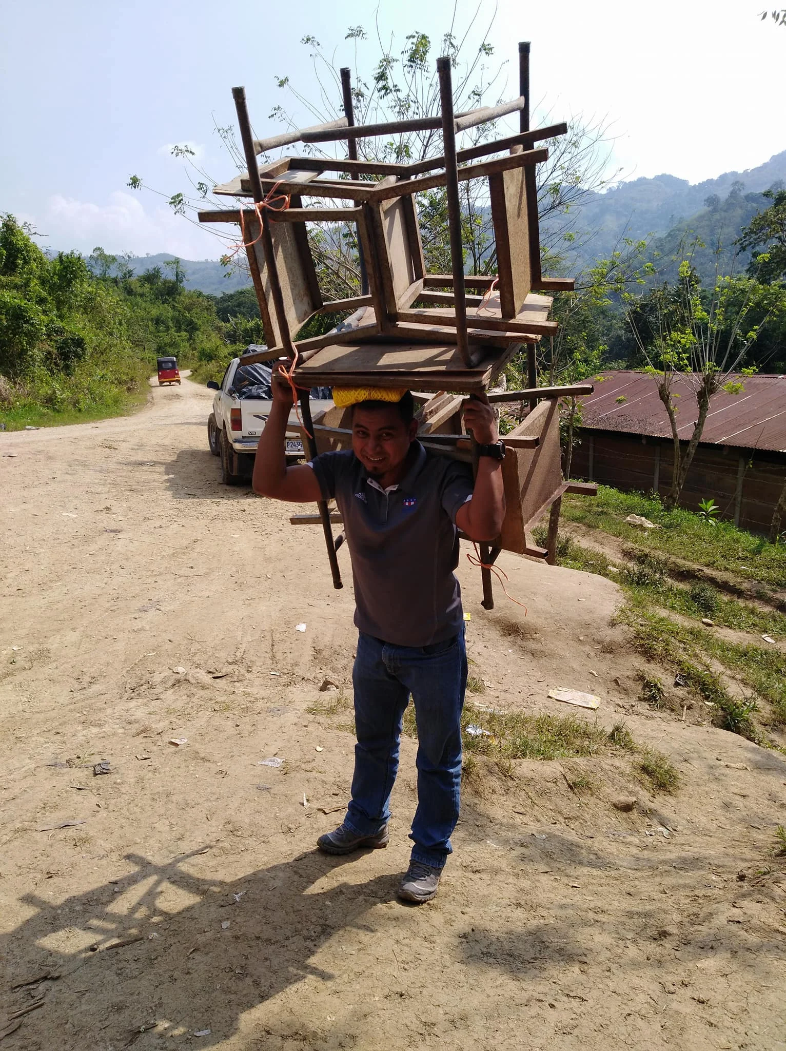 volunteers carried the desks up the mountain and across a river to bring them to the school.