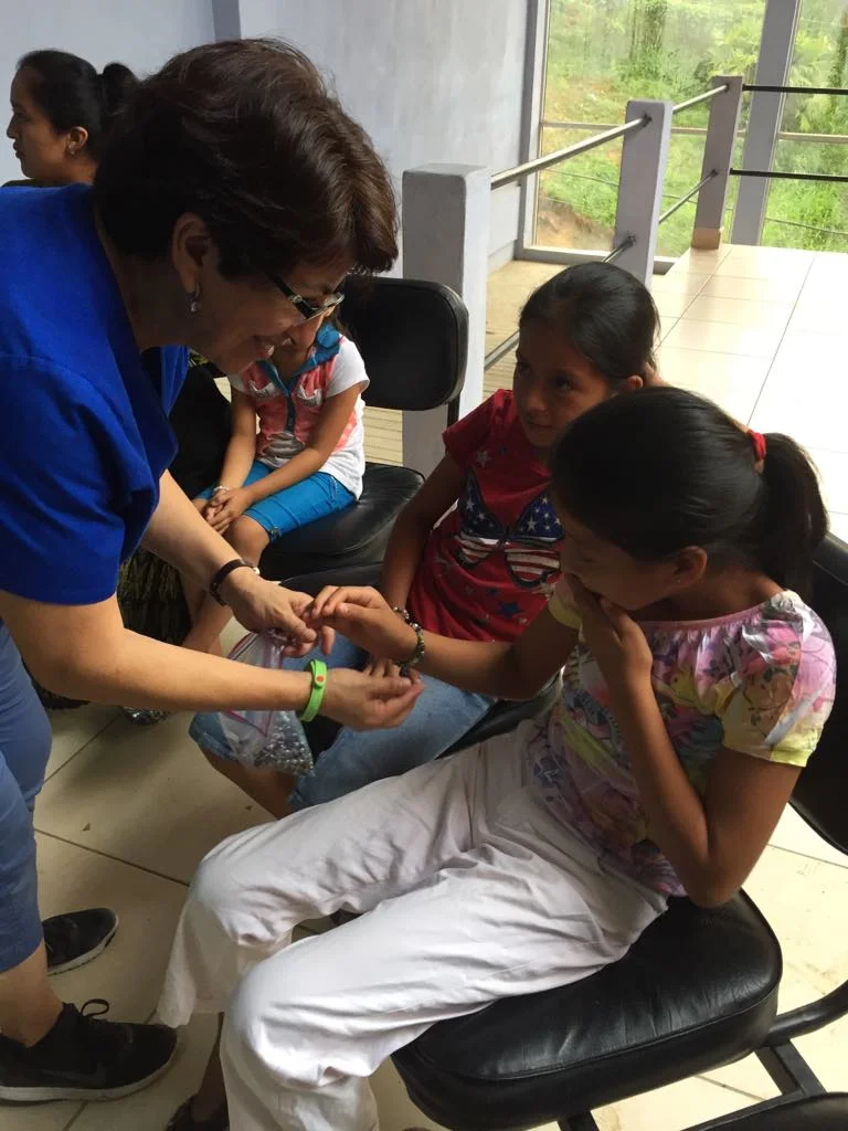 Ileana giving out bracelets that our friends from Fresno, California.
