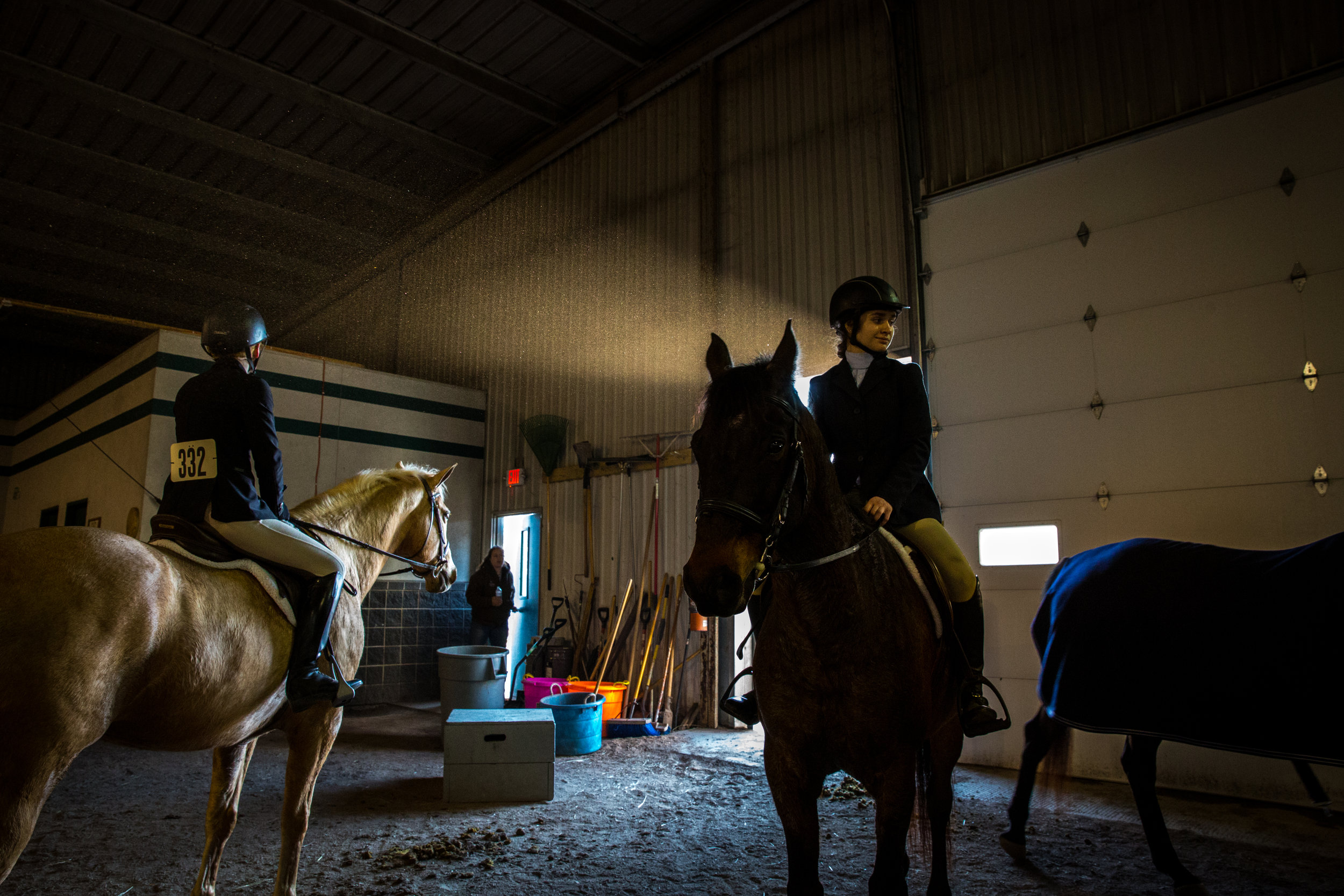  Katie Clark, left, and Isabel Gompper, right, prepare for the Open Hunter division beside the course during William Woods University Spring Fun Show in Fulton, Missouri on Saturday, Feb. 25, 2017. 