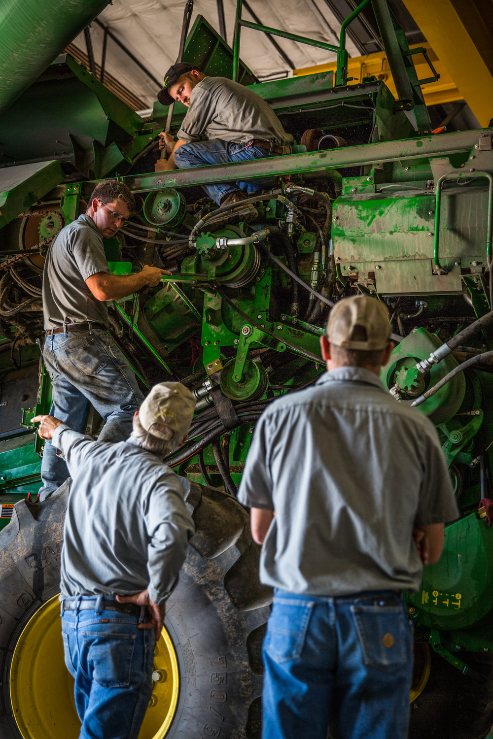  Service technicians work on repairing a combine in the Sydenstricker John Deere dealership in Mexico, Missouri on Tuesday, Oct. 4, 2016.  