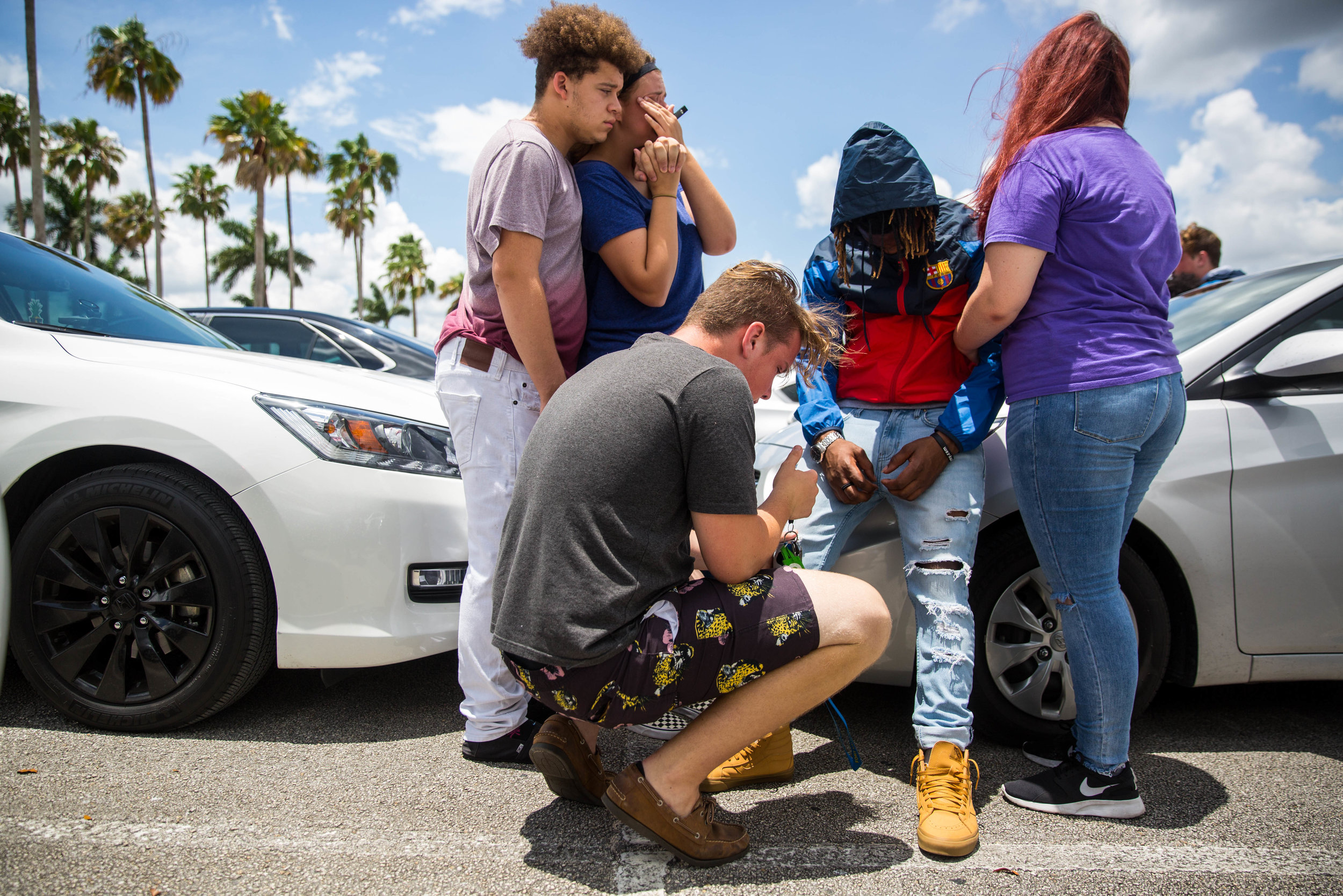  Friends comfort Sam Williams, middle, at a parking lot in front of the BB&amp;T Center in Sunrise, Florida after the memorial for rapper XXXTentacion on Wednesday, June 27, 2018. 