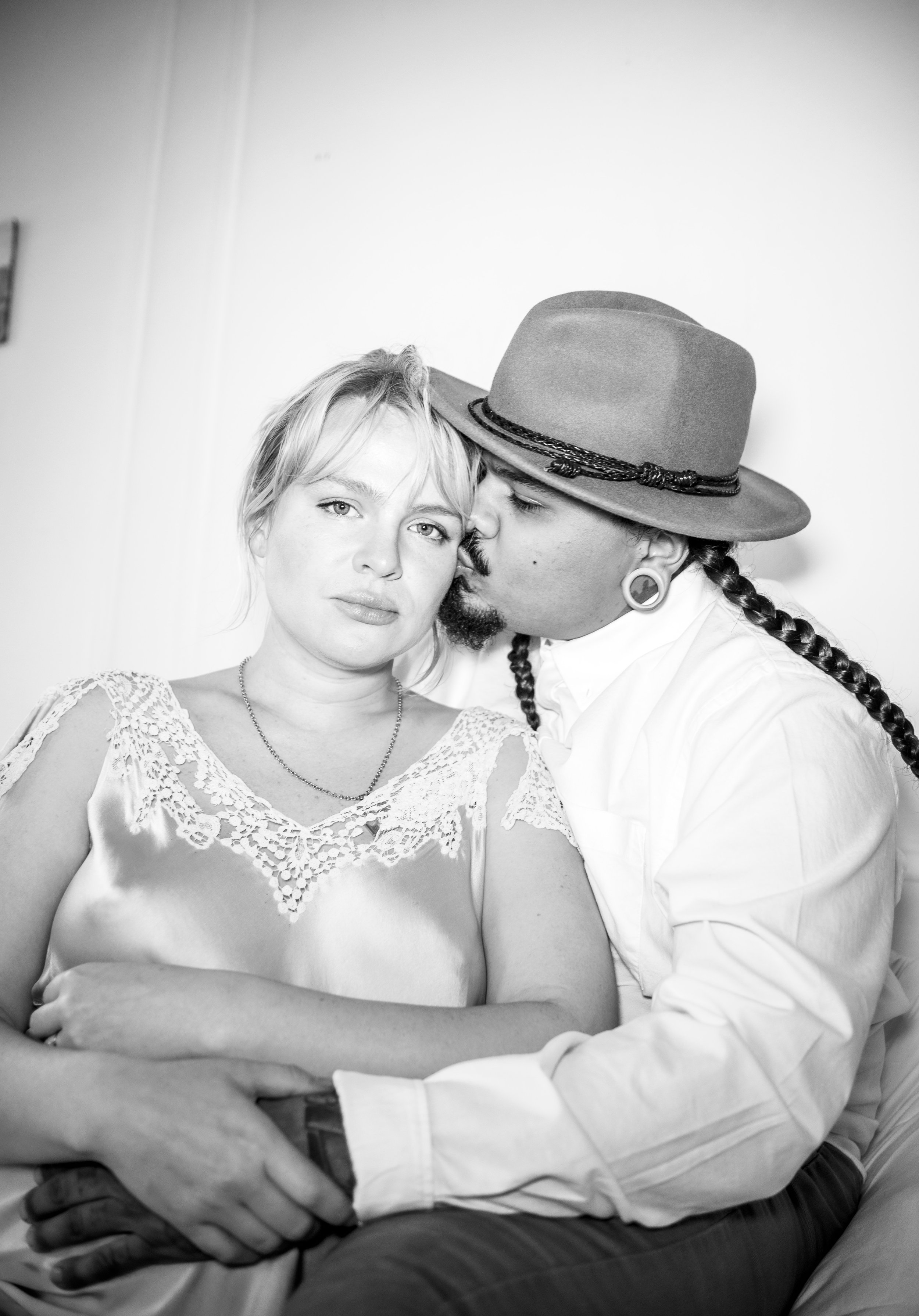 Black and white portrait of couple kissing.