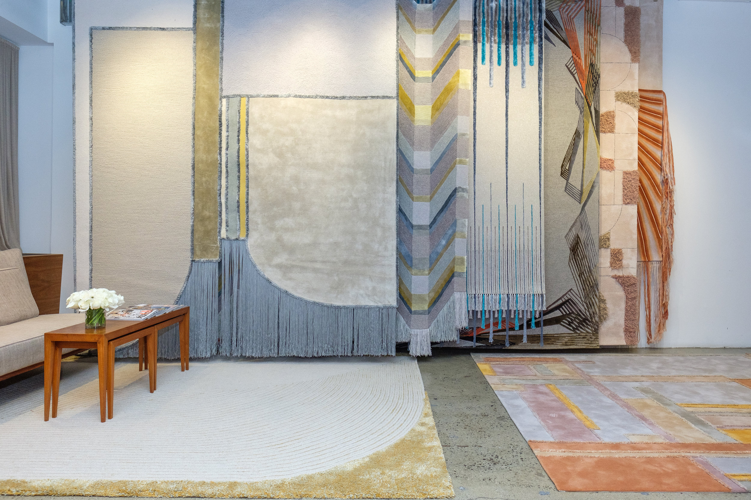Five of the rugs are designed to be hung as tapestries — but they also have floor-ready versions