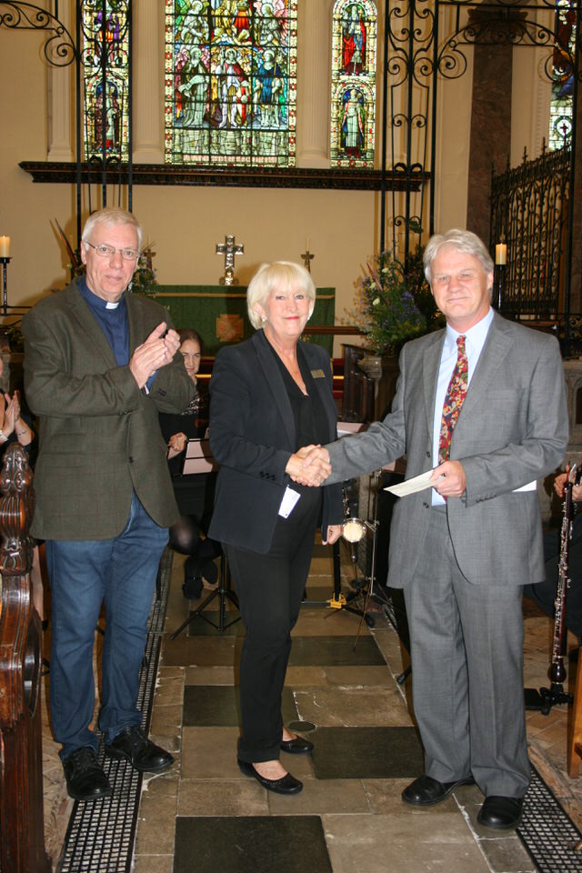Jane Williams from The Greenbank Hotel hands over a cheque to Michael White, organiser of the concert series.