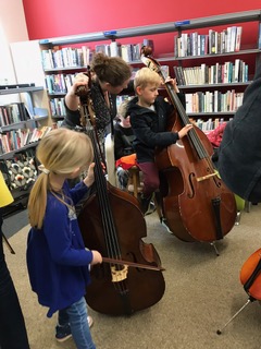 Brother and sister Erin aged 6 and Rowan aged 8 from Truro playing the double bass: