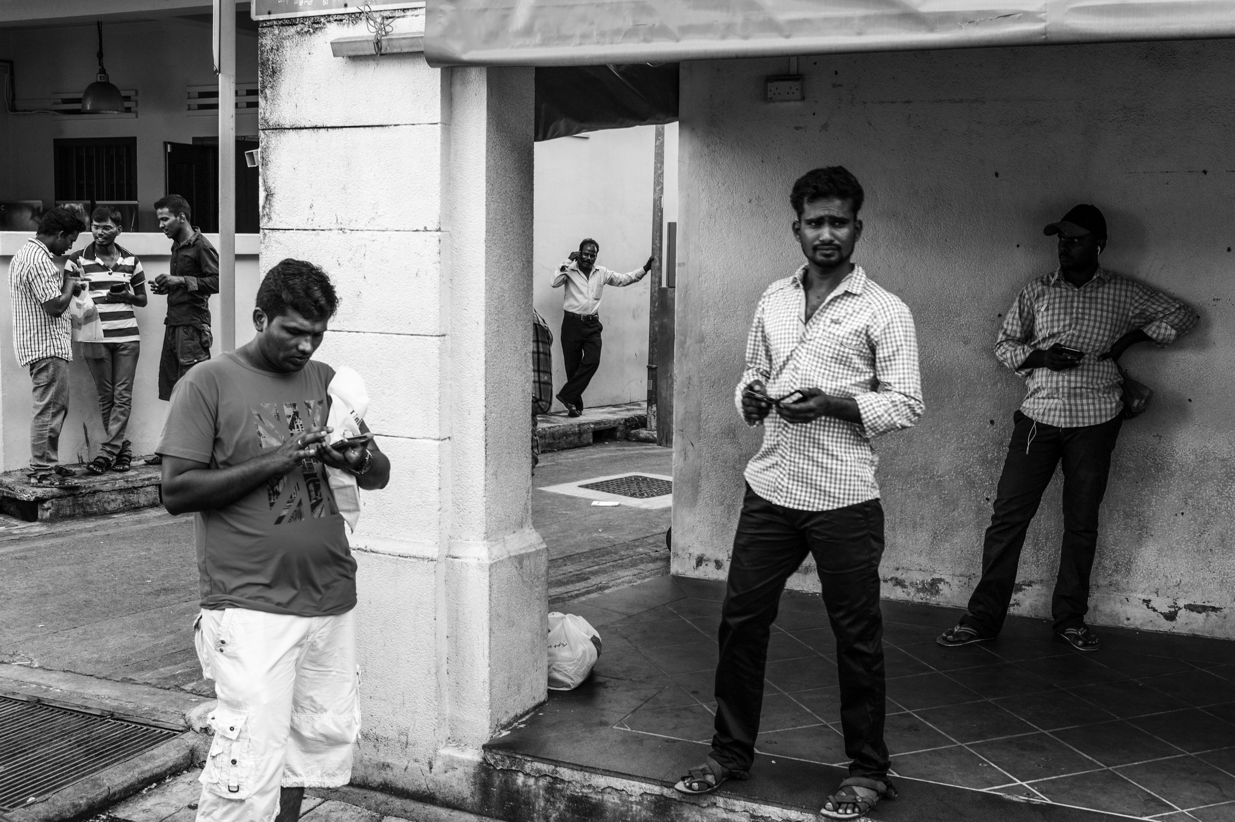   A simple pastime . Men stand and occupy the streets for long hours singly and in cliques, almost as if to see and be seen only . 