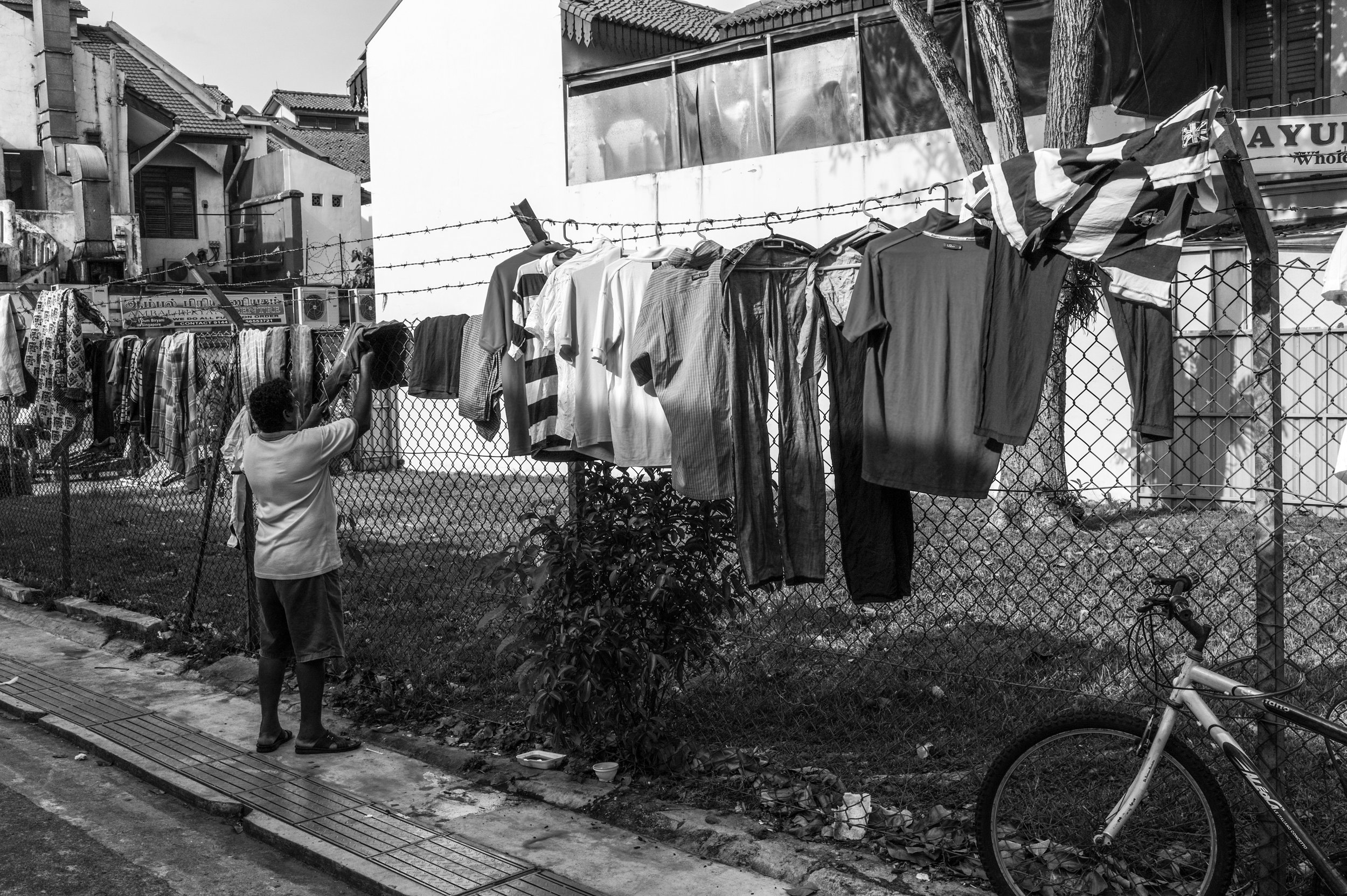  Dhoby.&nbsp; A man openly airs and displays his laundry among his contemporaries' along an alleyway.&nbsp; 