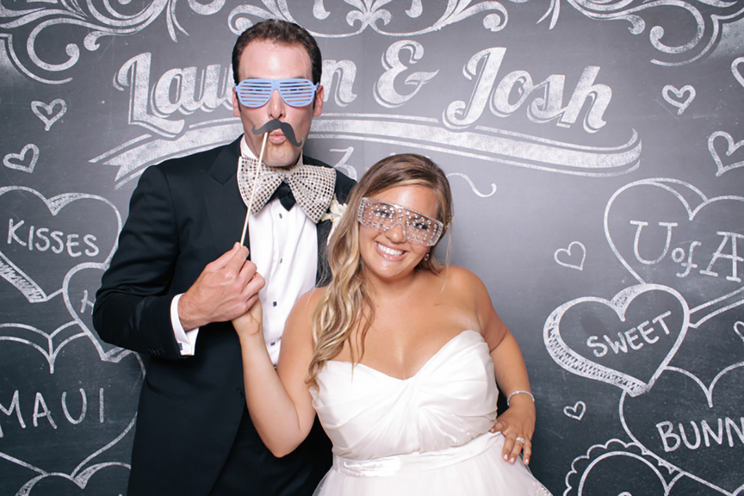 bride and groom in front of an open air photo booth for wedding in Brooklyn NYC.
