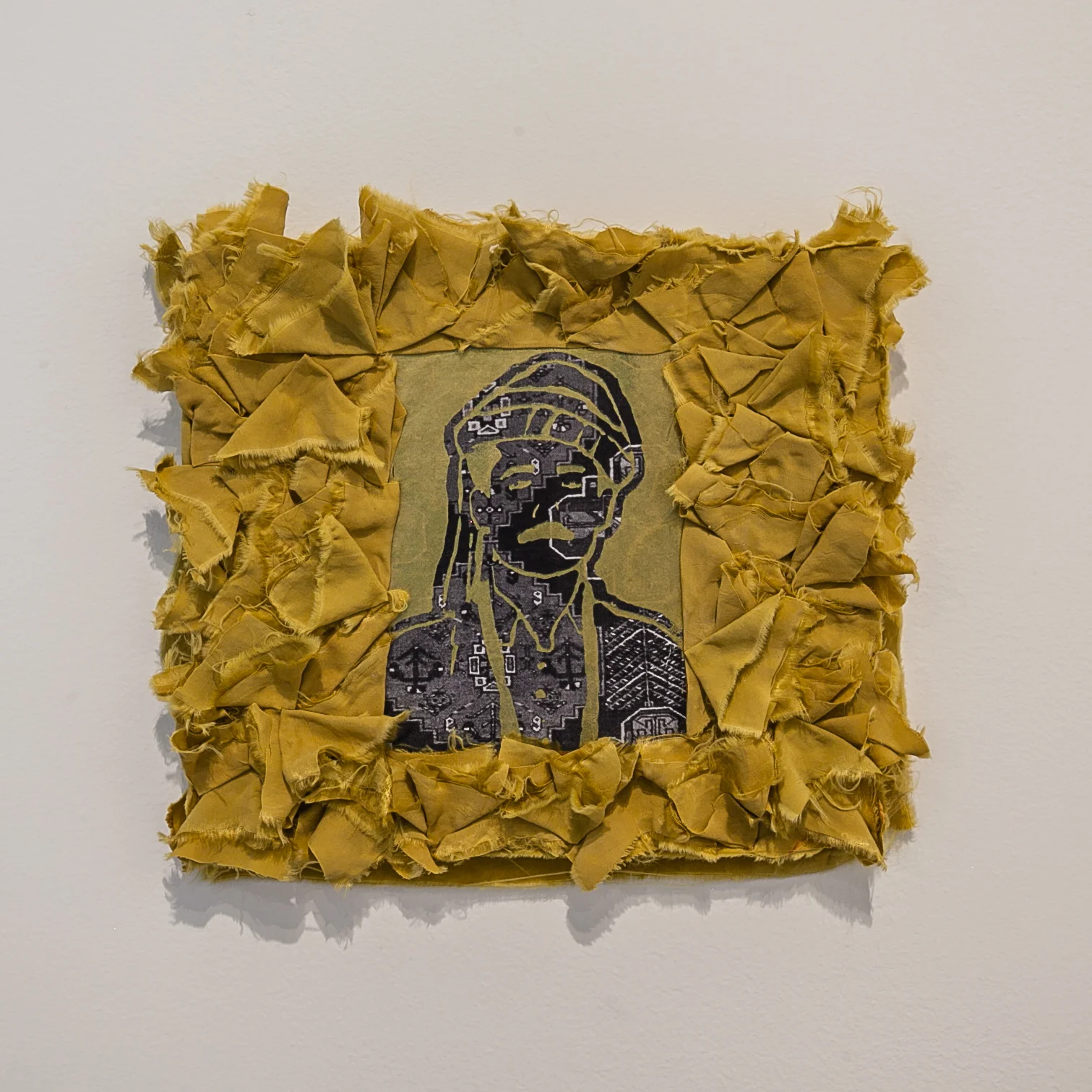 Nuveen Barwari (Nashville, TN) The Voiceless Kurd, 2018 Medium: Ink, paper, fabric, on wood Dimensions: 8x9 inches “This is a Kurdish man wearing the traditional headdress. It is screen-printed on a photocopy of a Kurdish rug and it symbolizes the genocides, hardships and oppressions that Kurds have gone through. The rest of the world is not hearing their voices and cries because they are a stateless nation. The traditional Kurdish rug depicted in the piece is symbolic because a carpet is quieter to walk on than a hard surface floor and it absorbs sound from the footsteps.” – Nuveen Barwari
