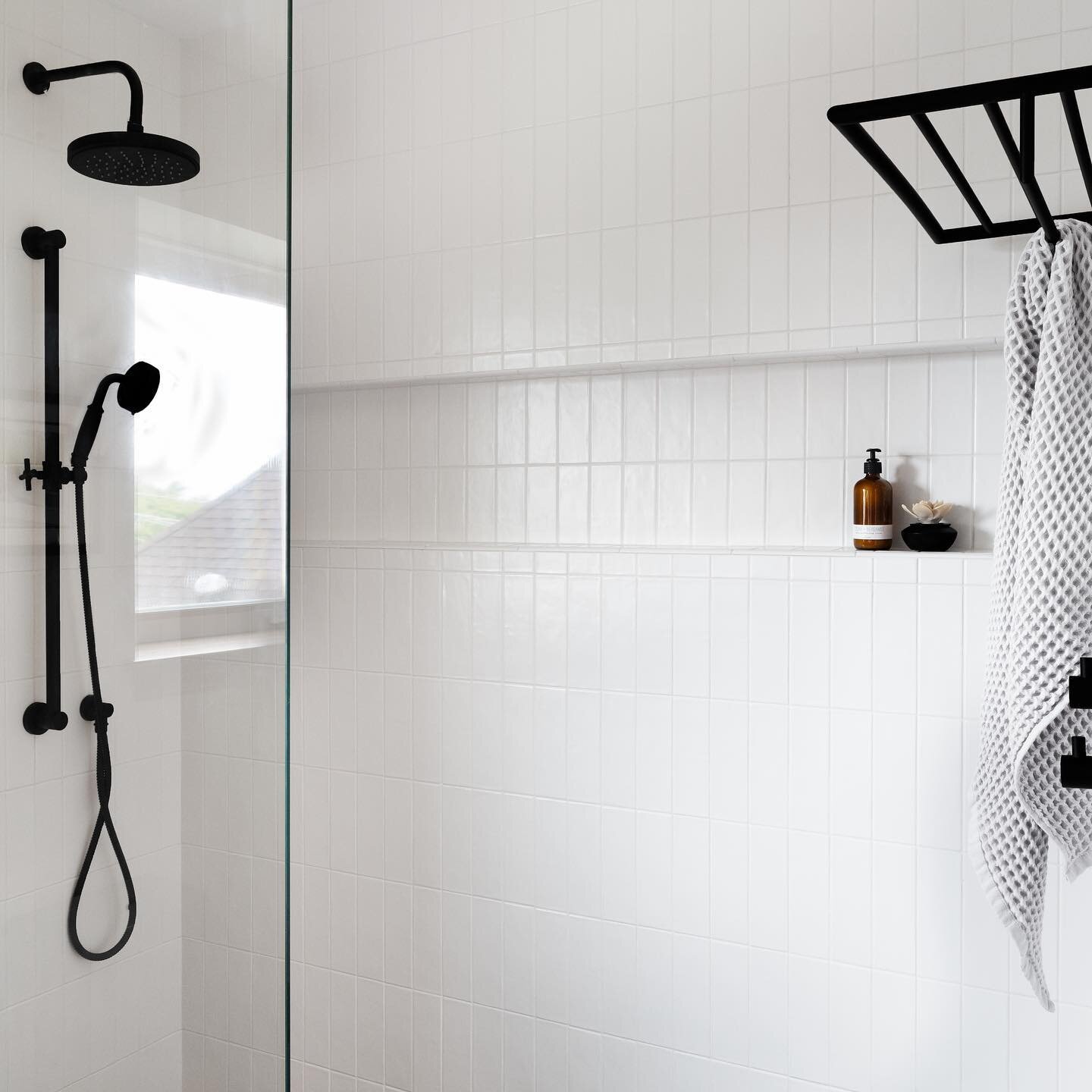 Unless I&rsquo;m working on a project with full permission to get really playful with color, I like the appeal of a really crisp shower interior. In this case, the simple white tile pairs perfectly with the black fixtures to create an inviting, clean