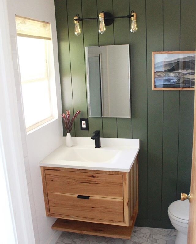 Simple, clean floating vanity and some green shiplap. This was my quarantine home project. Vanity is hickory wood and picture frame to match. I made the black handle from angle iron. Fun project.