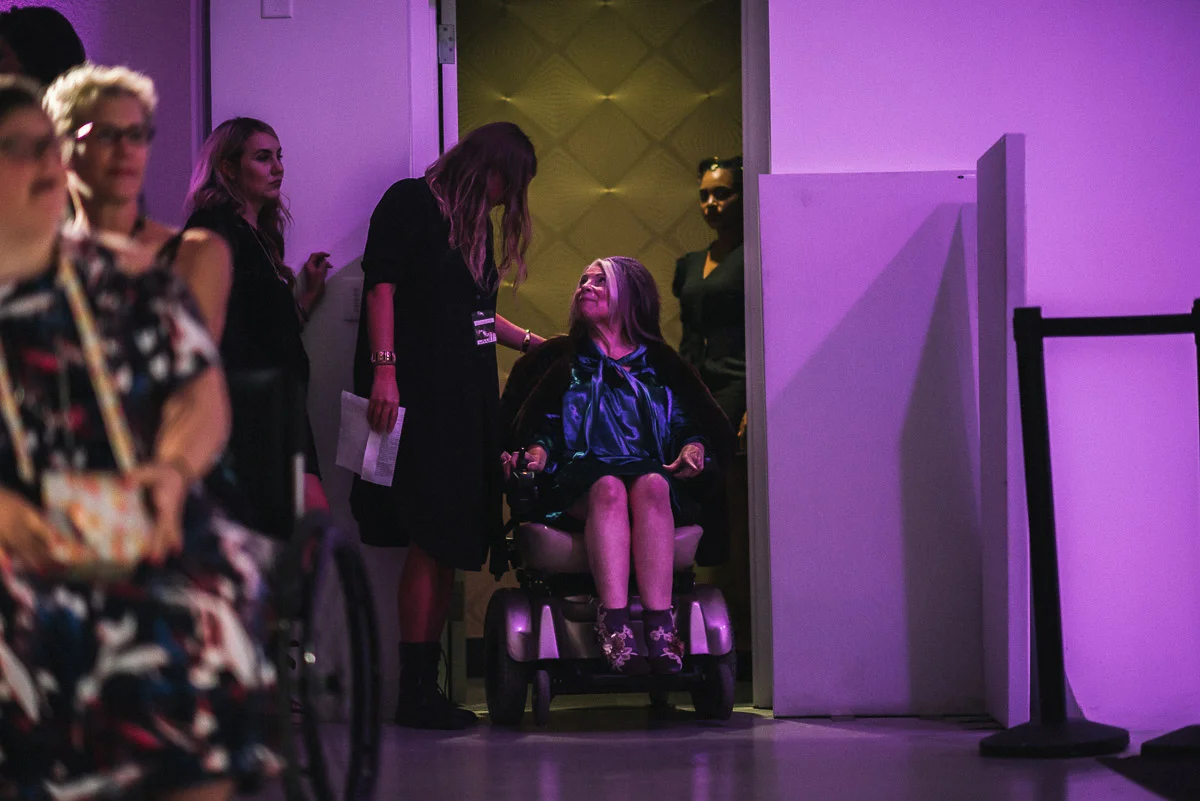 (pictured from left to right) Audience members, Laural Grell (designer of A Lady of The Lake), Runway coordinator Bobbi Jo, FIFEB Co- Founder and model Alicia Searcy wearing A Lady of The Lake and Tribe Model Dalaina Kimbro also wearing A Lady of the Lake shot by Snappylifestyle