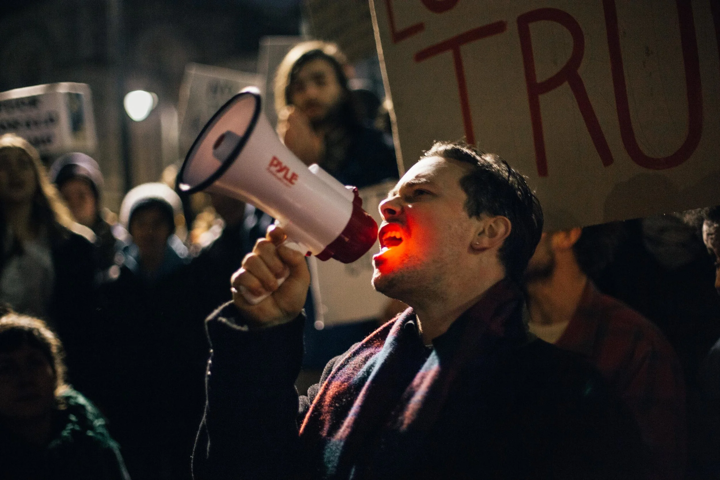 Ben Kritikos, organiser of Falmouth’s protest against Donald Trump’s so-called “Muslim ban”, leads the protester's chanting through a megaphone. Falmouth, Cornwall, UK. 30th Jan 2017.