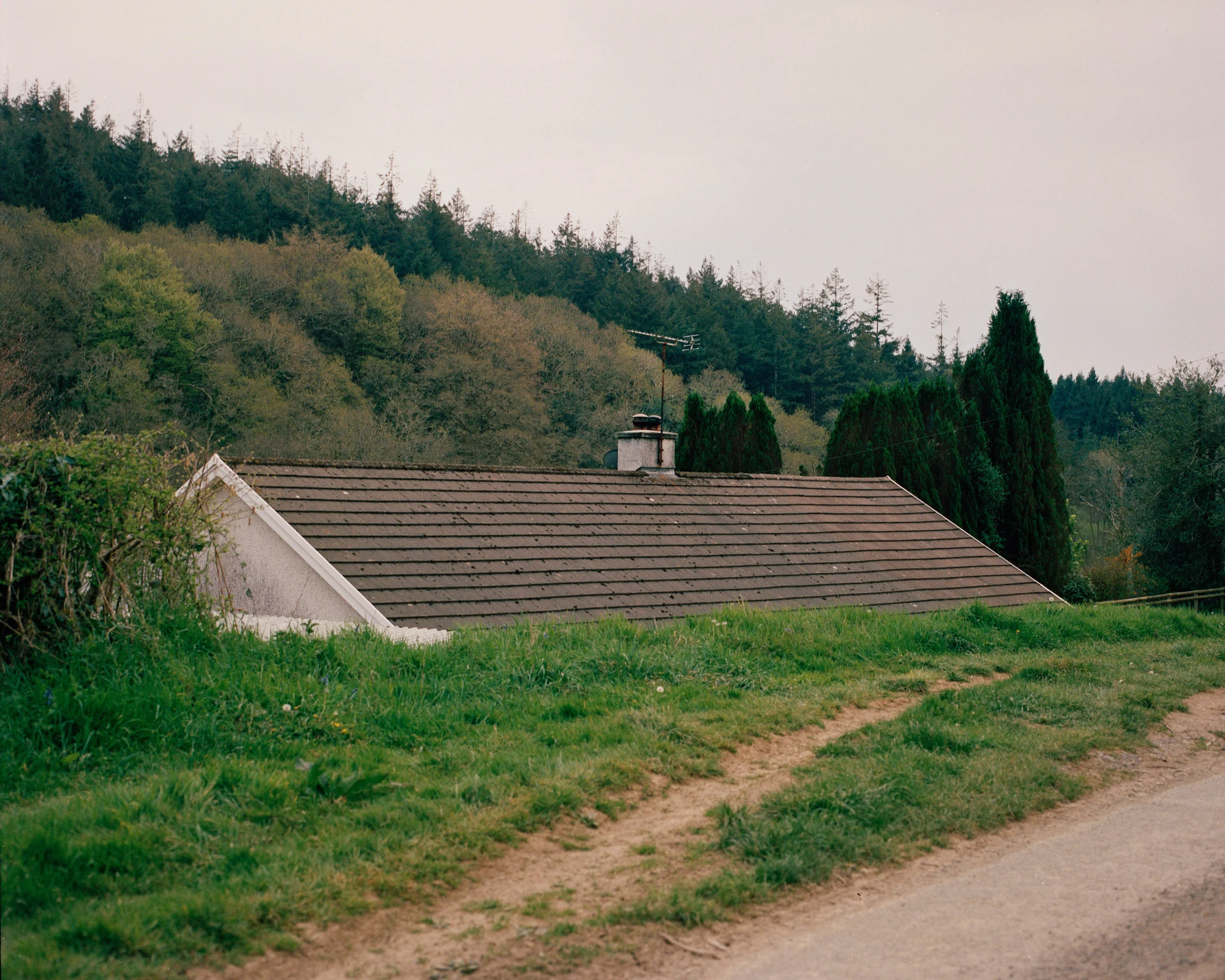 A farm house sits in a valley along the South road leaving Herodsfoot.